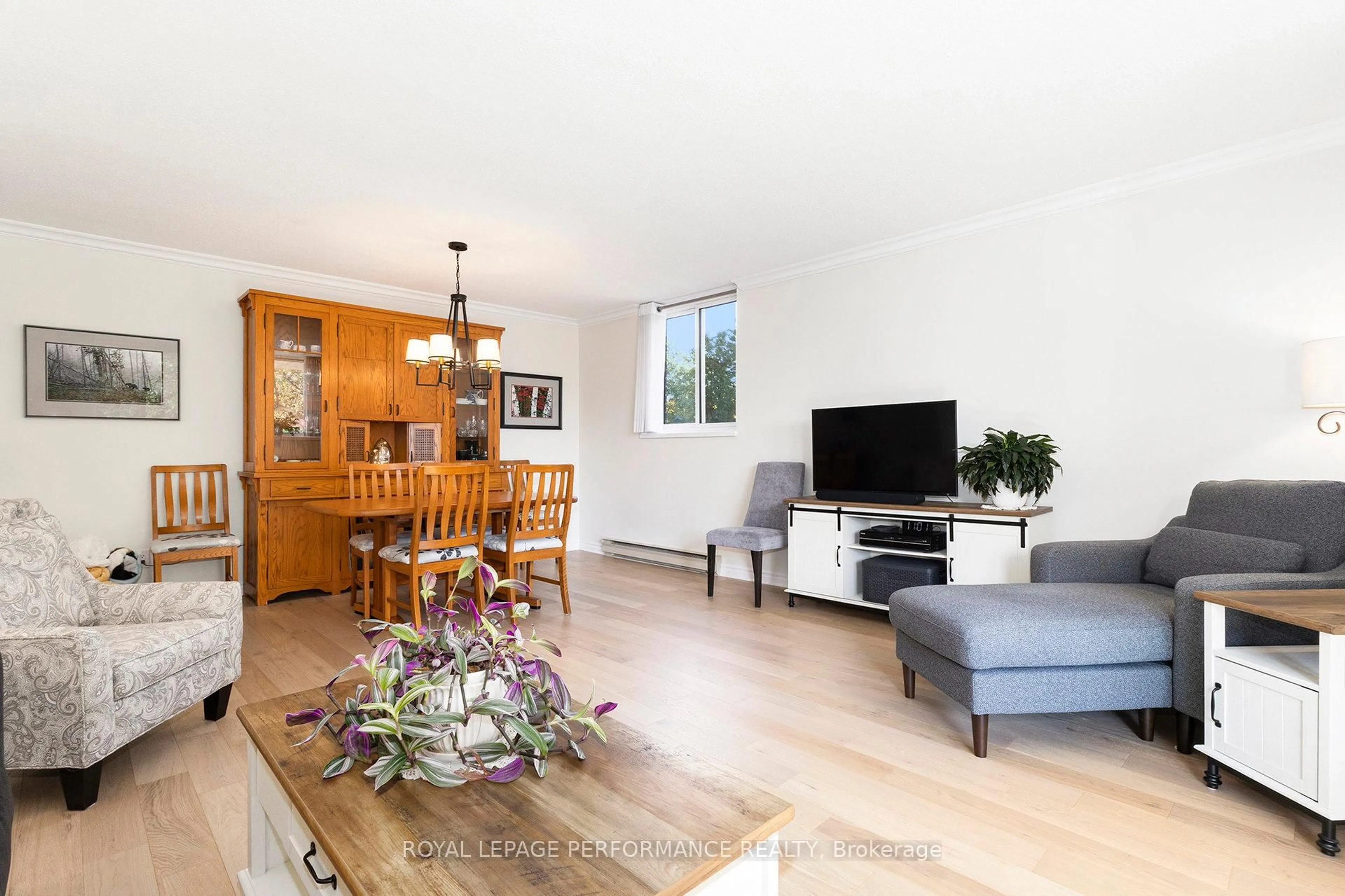 Living room with furniture, wood/laminate floor for 1705 Playfair Dr #101, Ottawa Ontario K1H 8P6