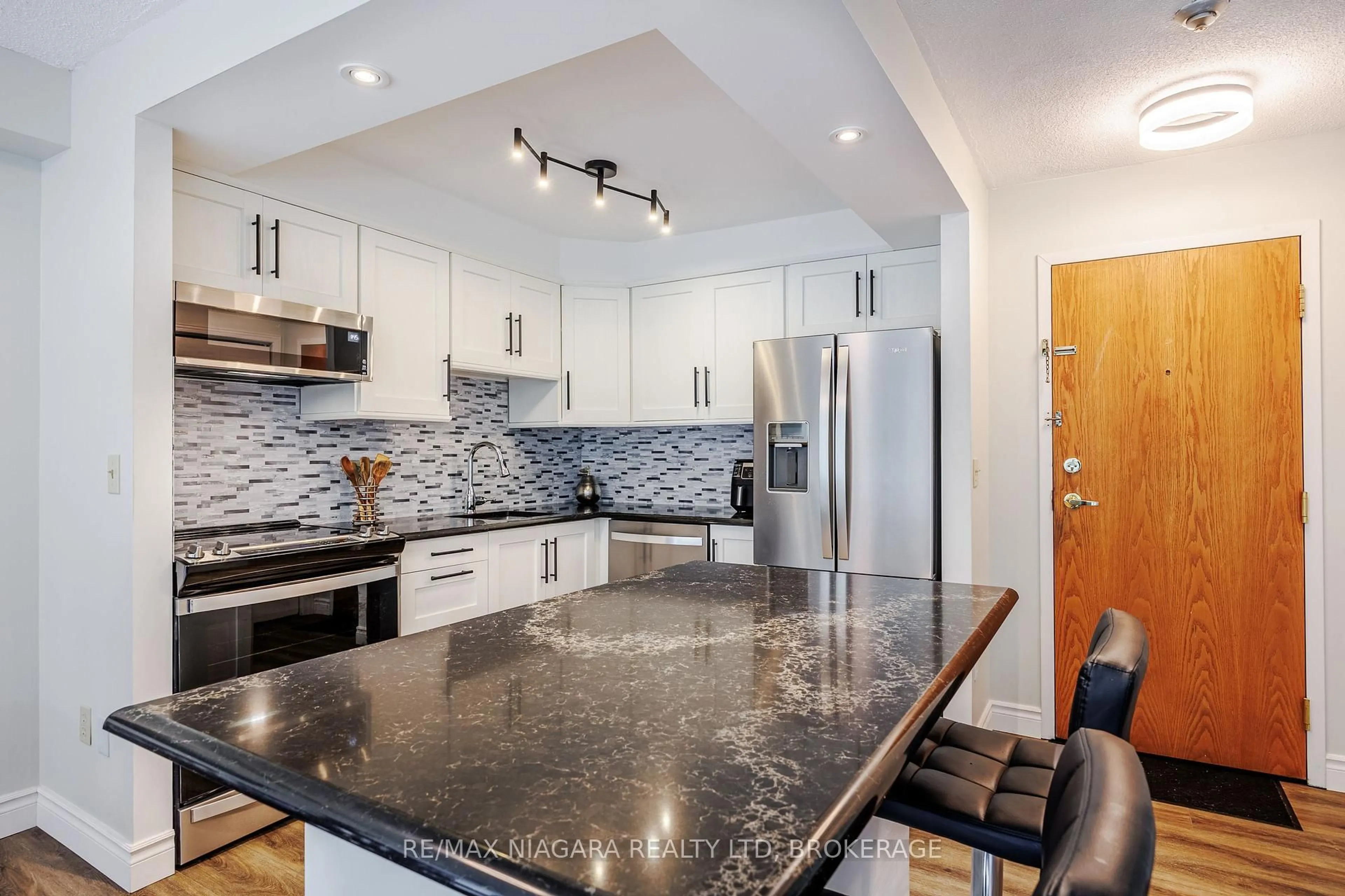 Open concept kitchen, ceramic/tile floor for 81 Scott St #307, St. Catharines Ontario L2N 7L5