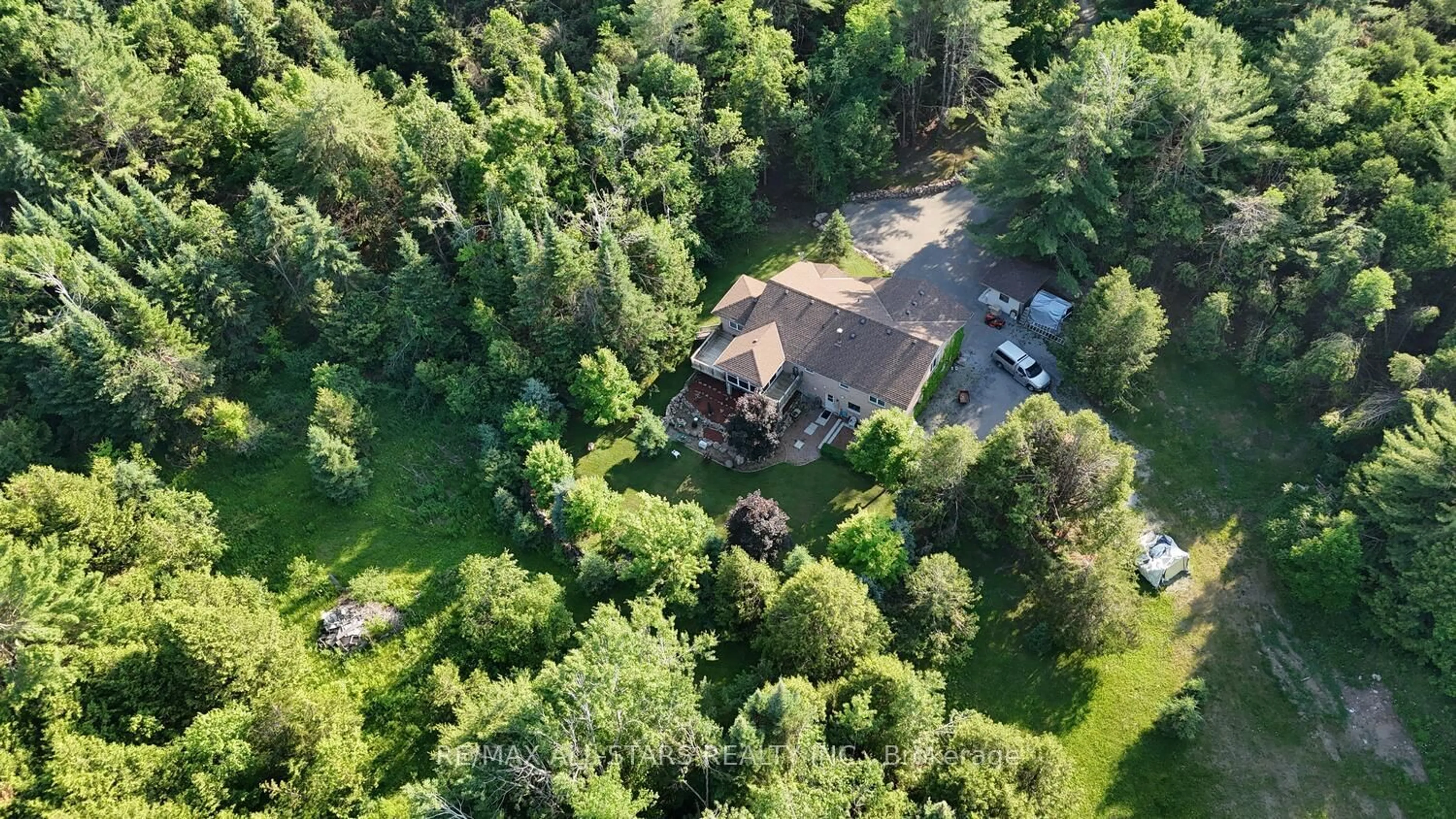 A pic from outside/outdoor area/front of a property/back of a property/a pic from drone, forest/trees view for 33 Tates Bay Rd, Trent Lakes Ontario K0M 1A0