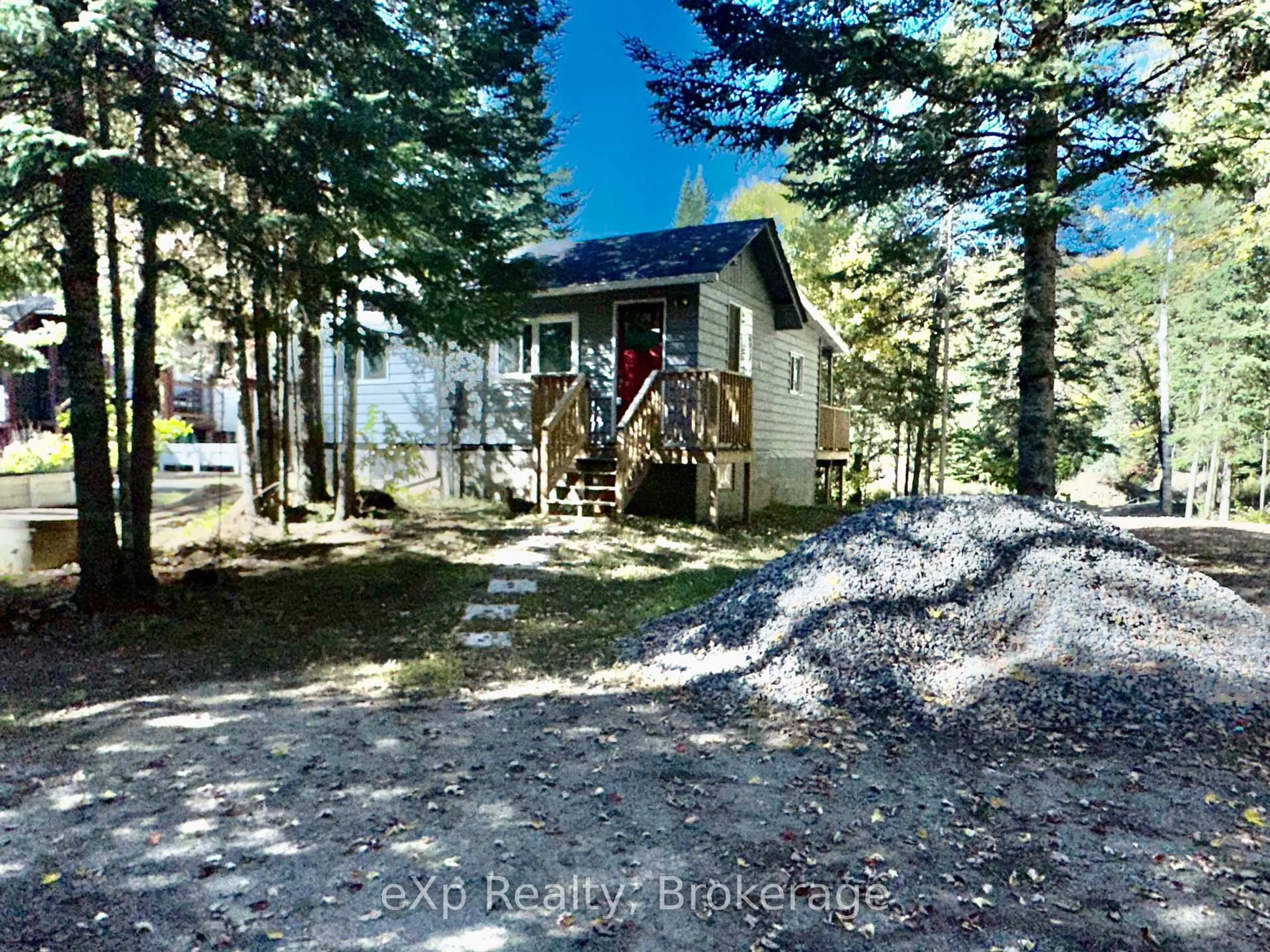 A pic from outside/outdoor area/front of a property/back of a property/a pic from drone, forest/trees view for 61 Robert Rd, Huntsville Ontario P1H 1L4