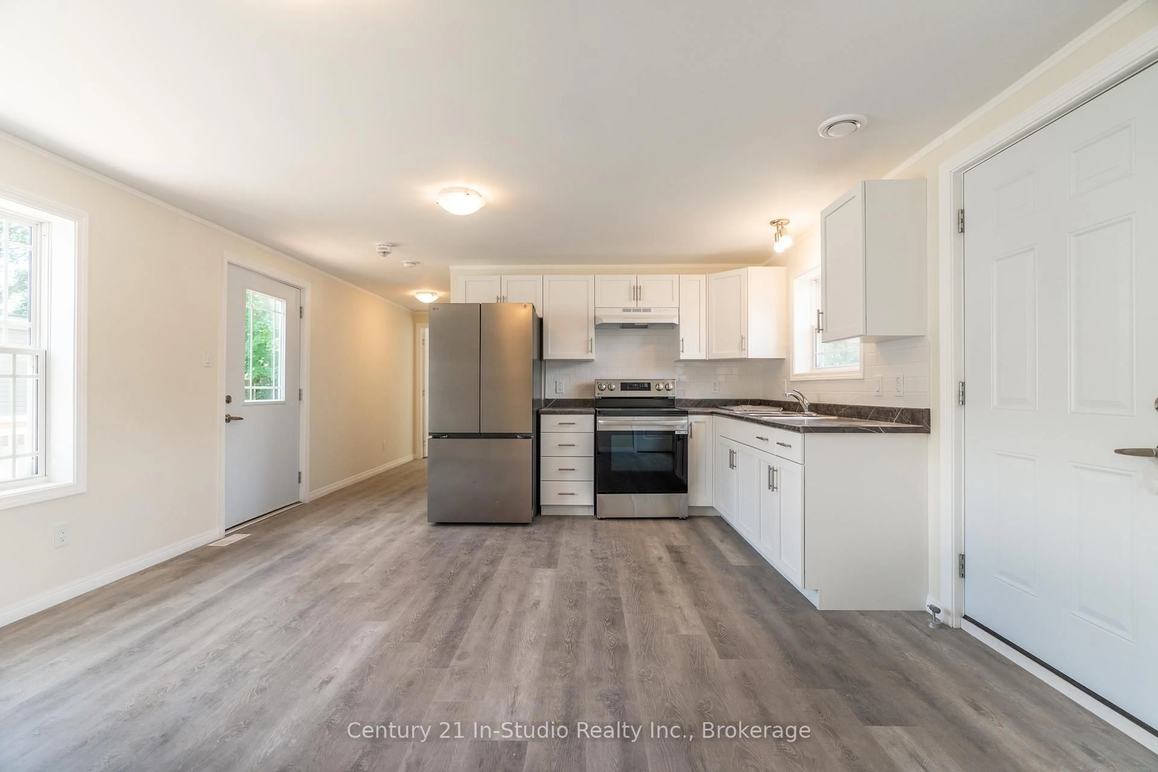 Open concept kitchen, wood/laminate floor for 8 Sussex Sq, Georgian Bluffs Ontario N4K 5N5