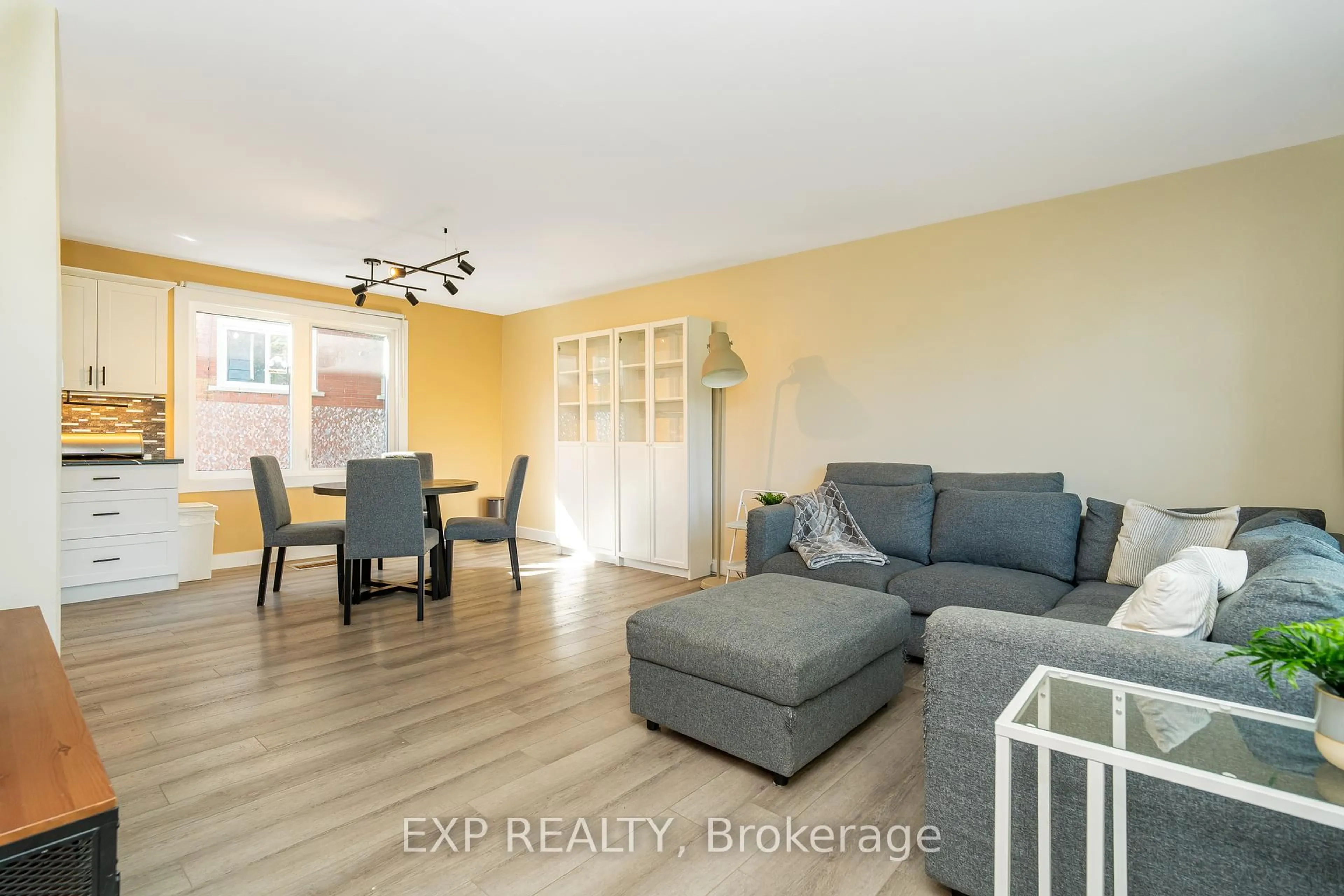 Living room with furniture, wood/laminate floor for 336 Poulin Ave, Ottawa Ontario K2B 5T8