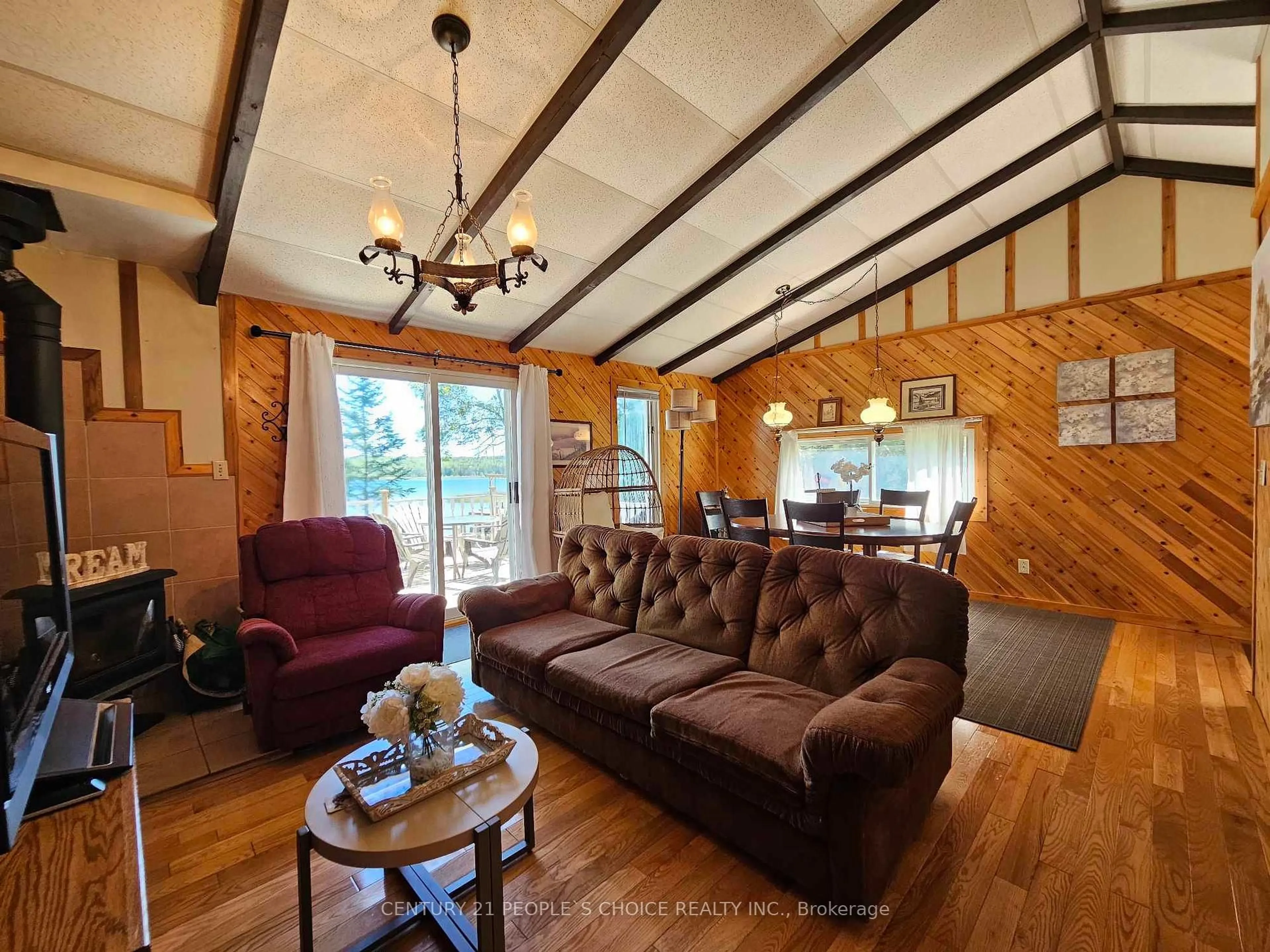 Living room with furniture, wood/laminate floor for 123 Waterview Lane, Assiginack Ontario P0P 1N0