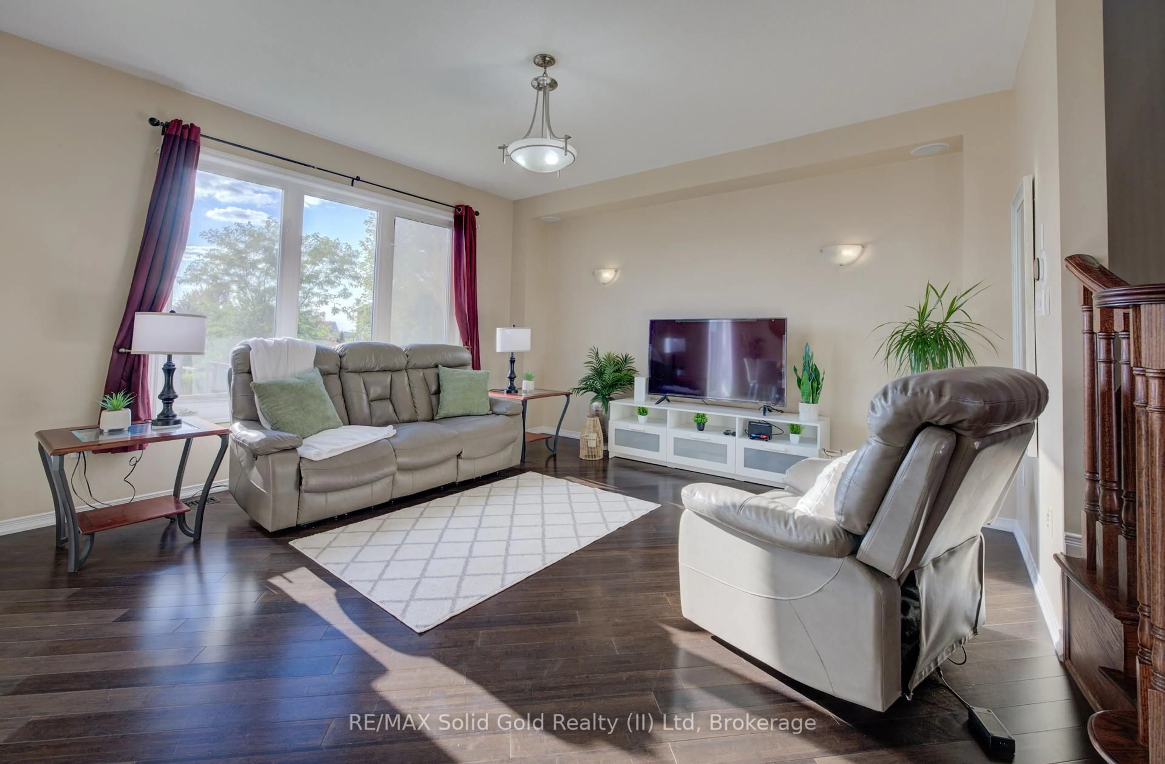 Living room with furniture, wood/laminate floor for 74 Norwich Rd, Woolwich Ontario N0B 1M0