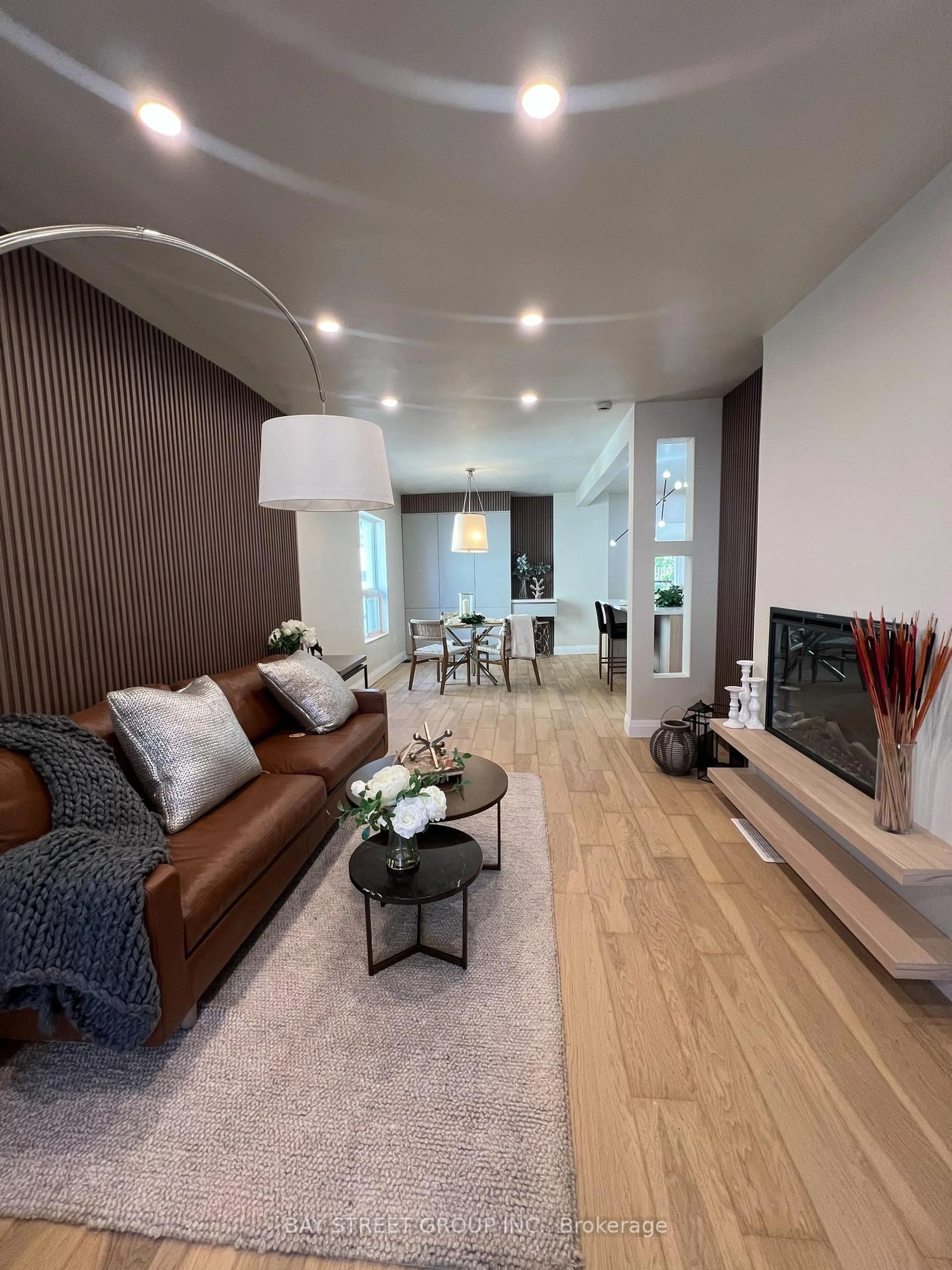 Living room with furniture, wood/laminate floor for 396 Emerald St, Hamilton Ontario L8L 5L9