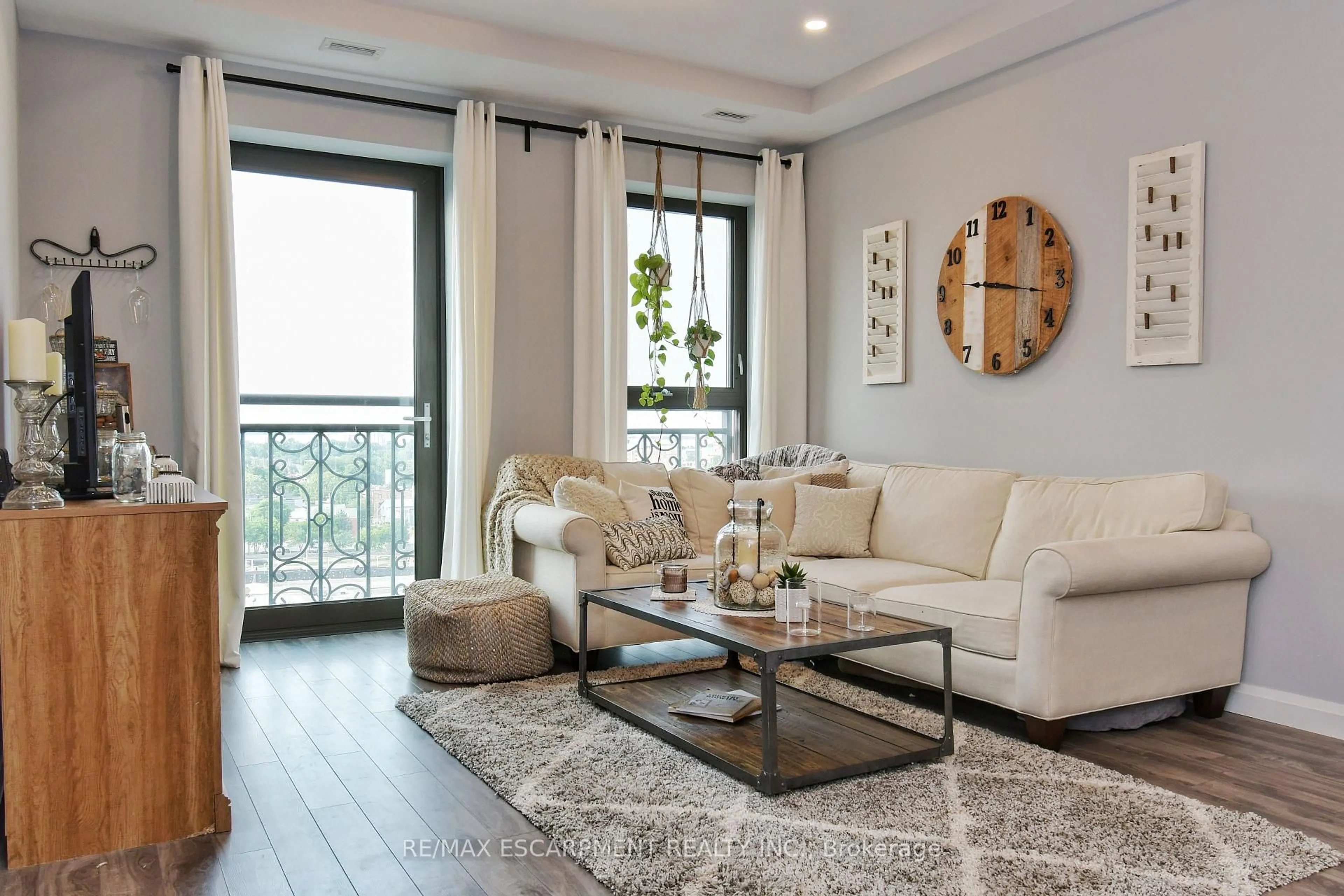 Living room with furniture, wood/laminate floor for 112 King St #903, Hamilton Ontario L8N 1A8