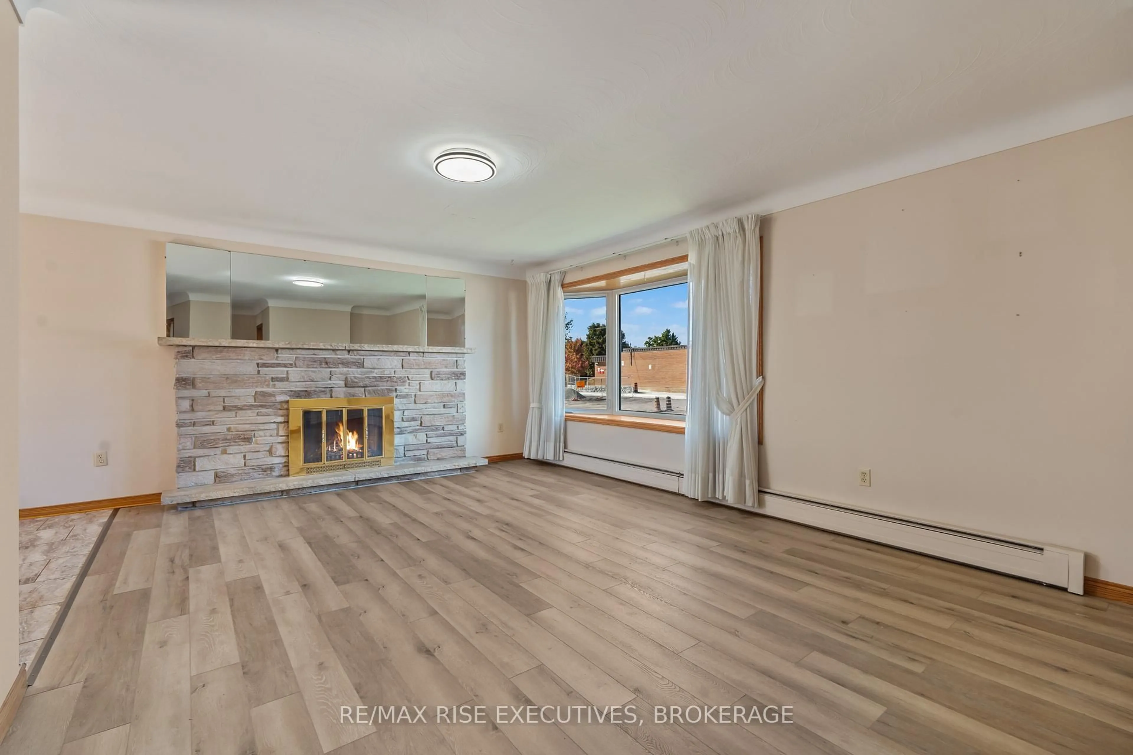 Living room with furniture, wood/laminate floor for 19 North St, Bissett Creek Ontario K0H 2H0