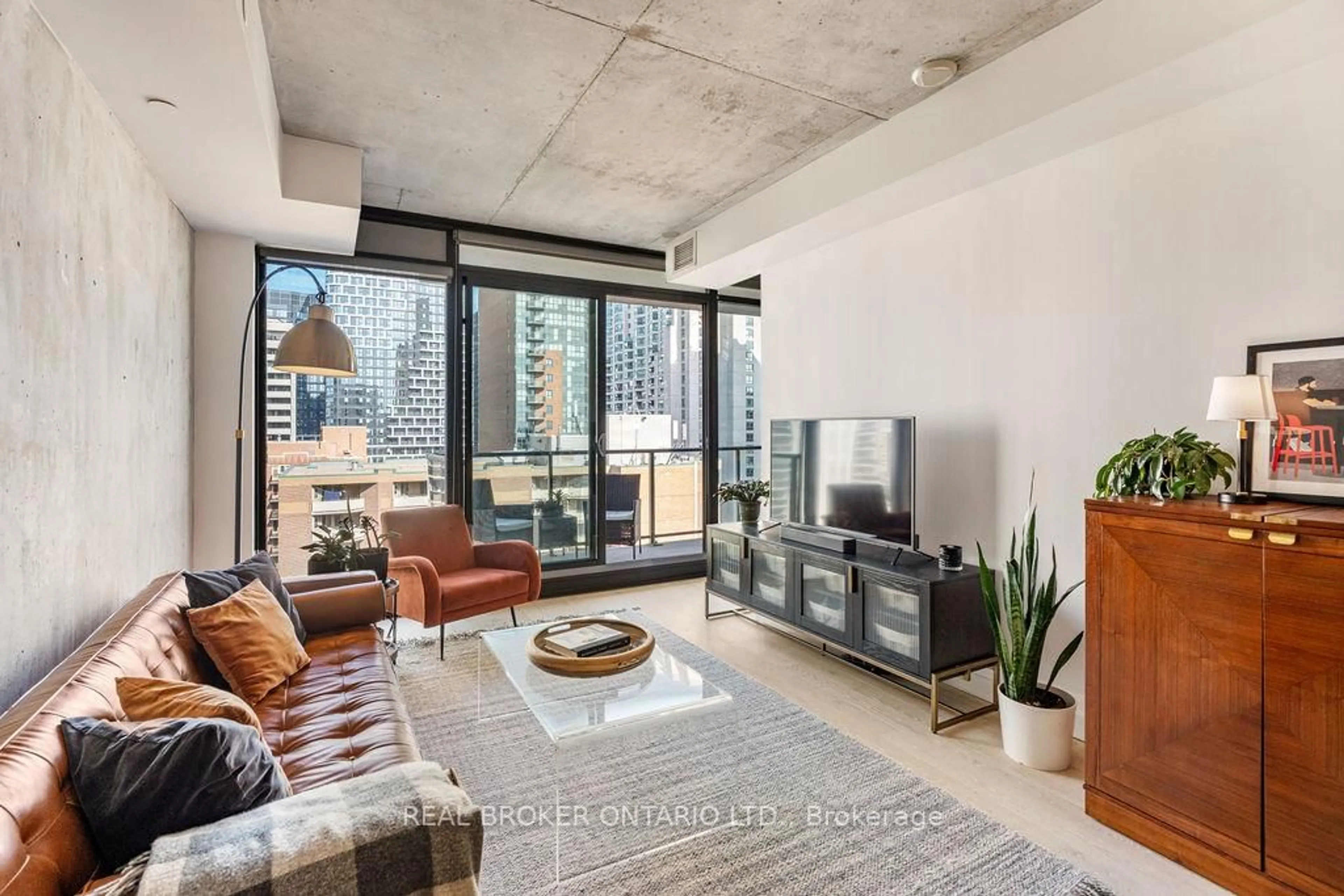 Living room with furniture, cement floor for 224 Lyon St #1111, Ottawa Ontario K1R 0C1