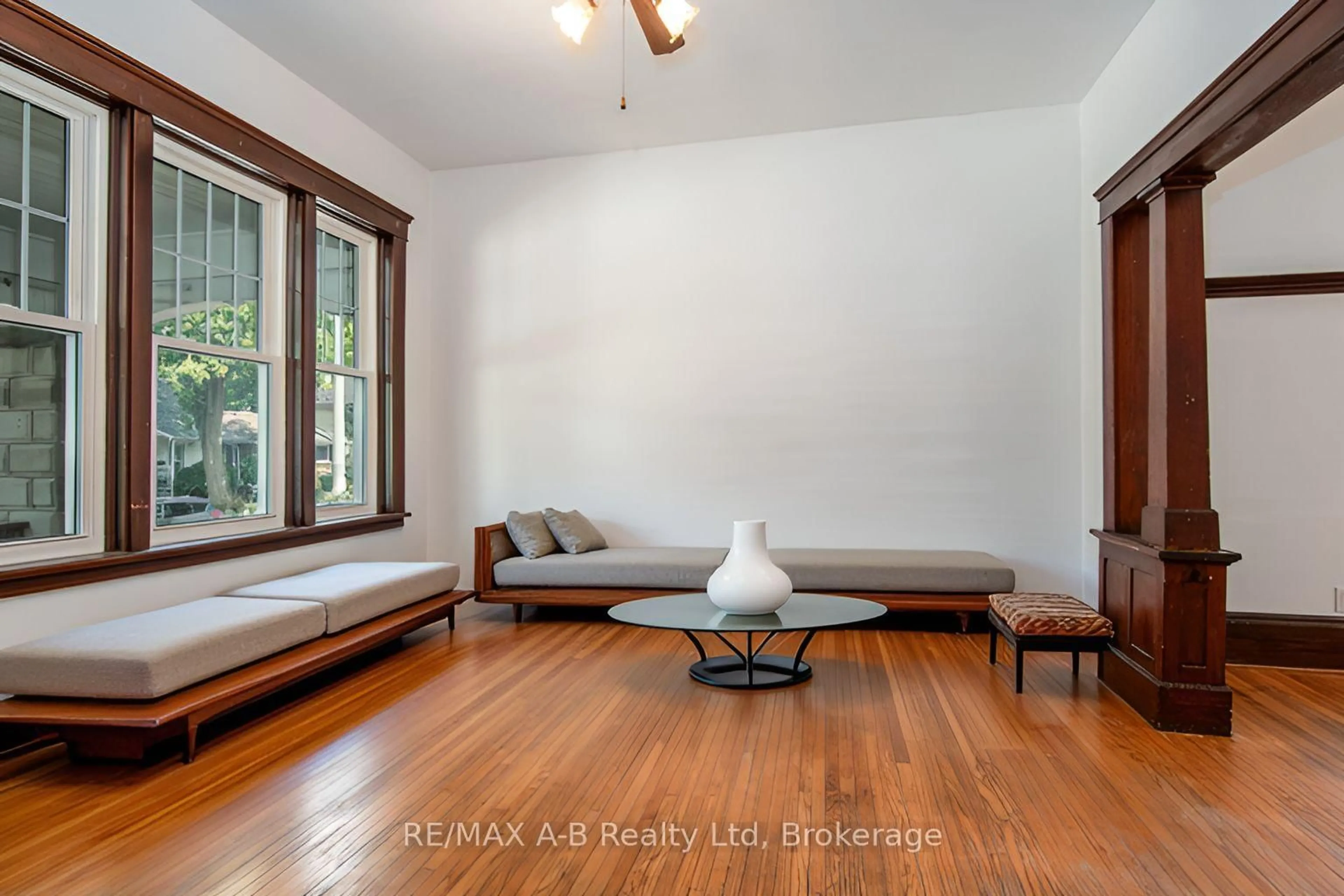 Living room with furniture, wood/laminate floor for 73 Stratford St, Stratford Ontario N5A 2H7