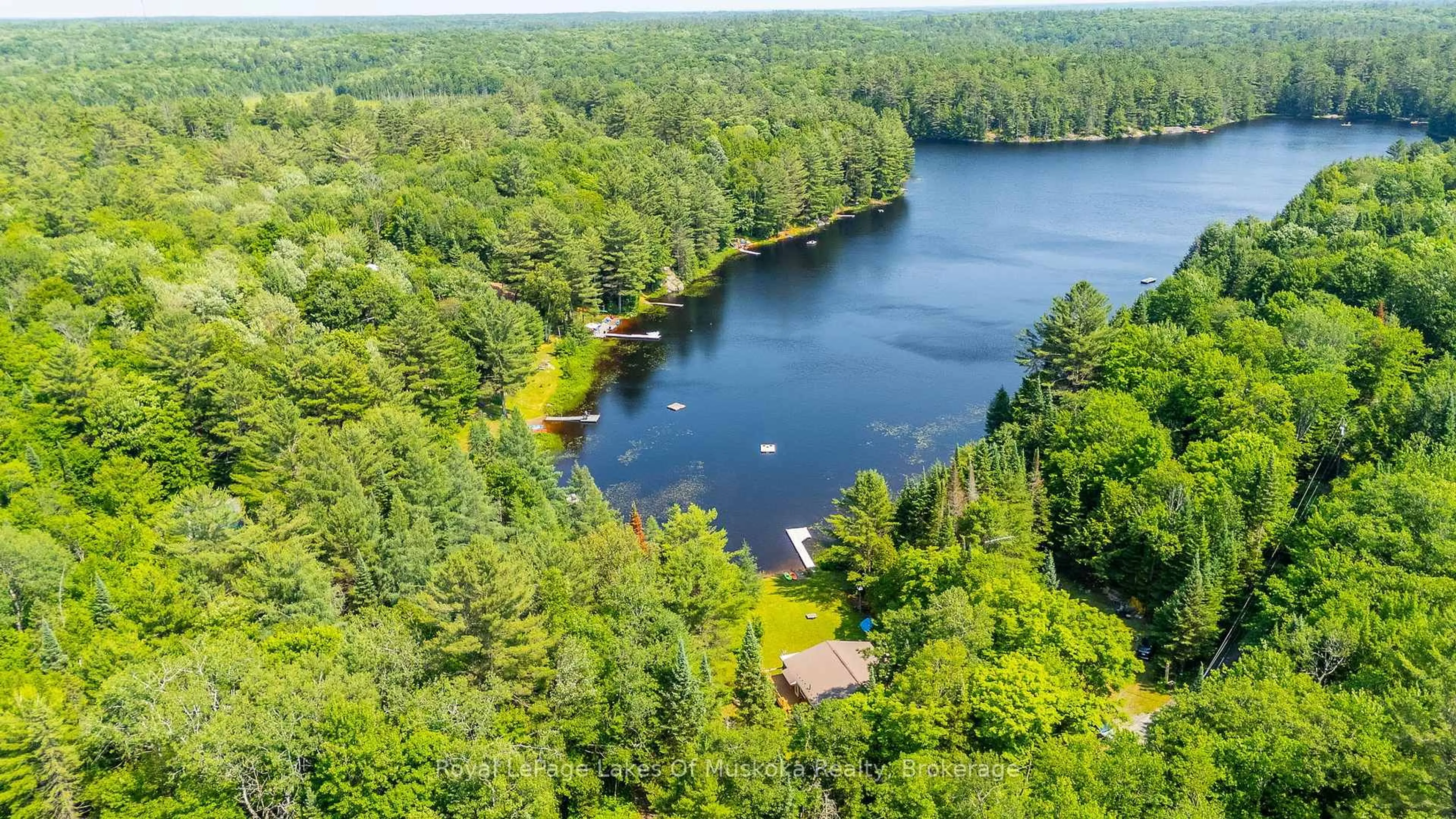 A pic from outside/outdoor area/front of a property/back of a property/a pic from drone, water/lake/river/ocean view for 1035 Atkins Lake Rd, Bracebridge Ontario P1L 1W9