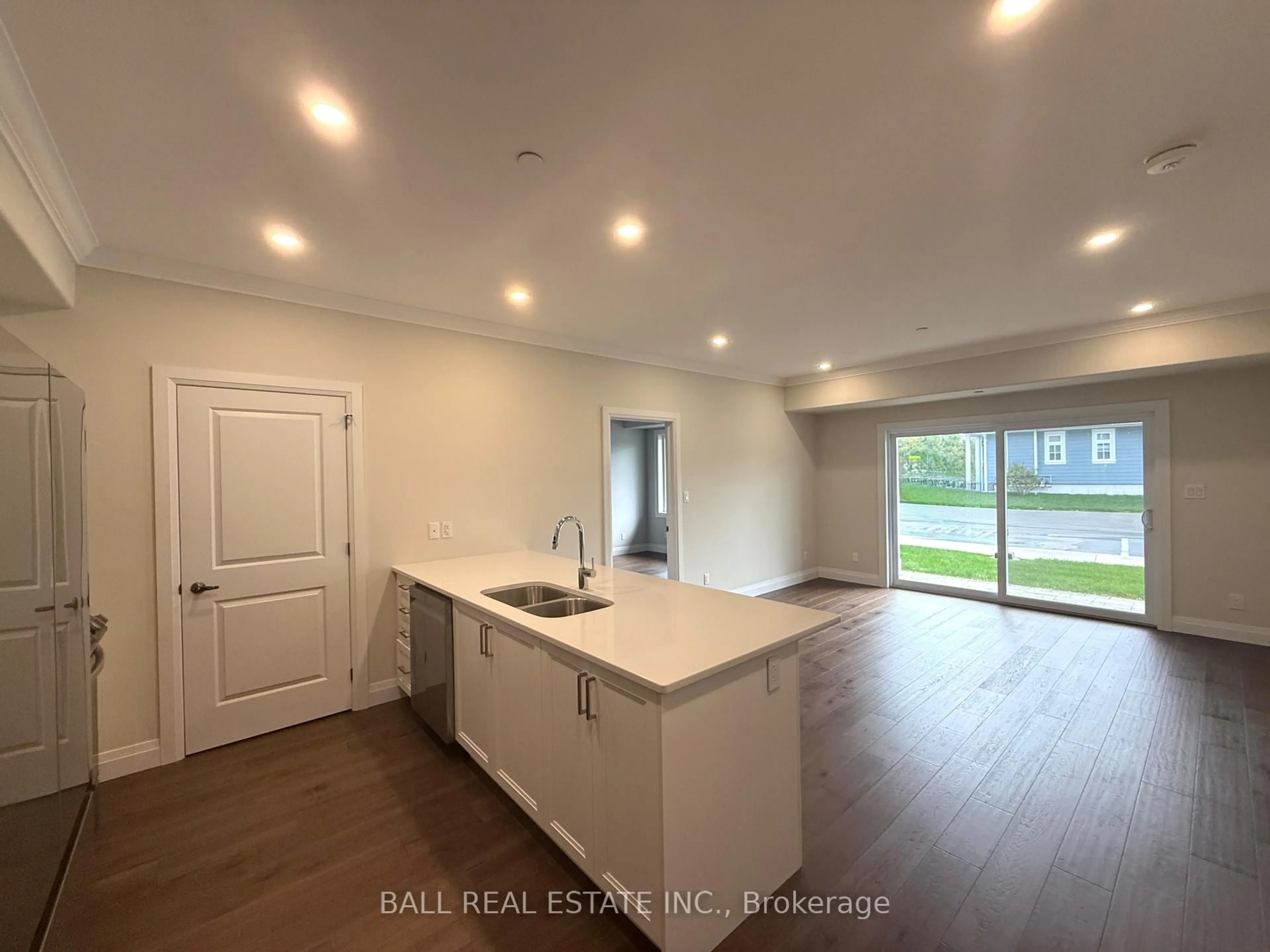 Open concept kitchen, wood/laminate floor for 19 Hampton Lane #102, Selwyn Ontario K0L 2H0