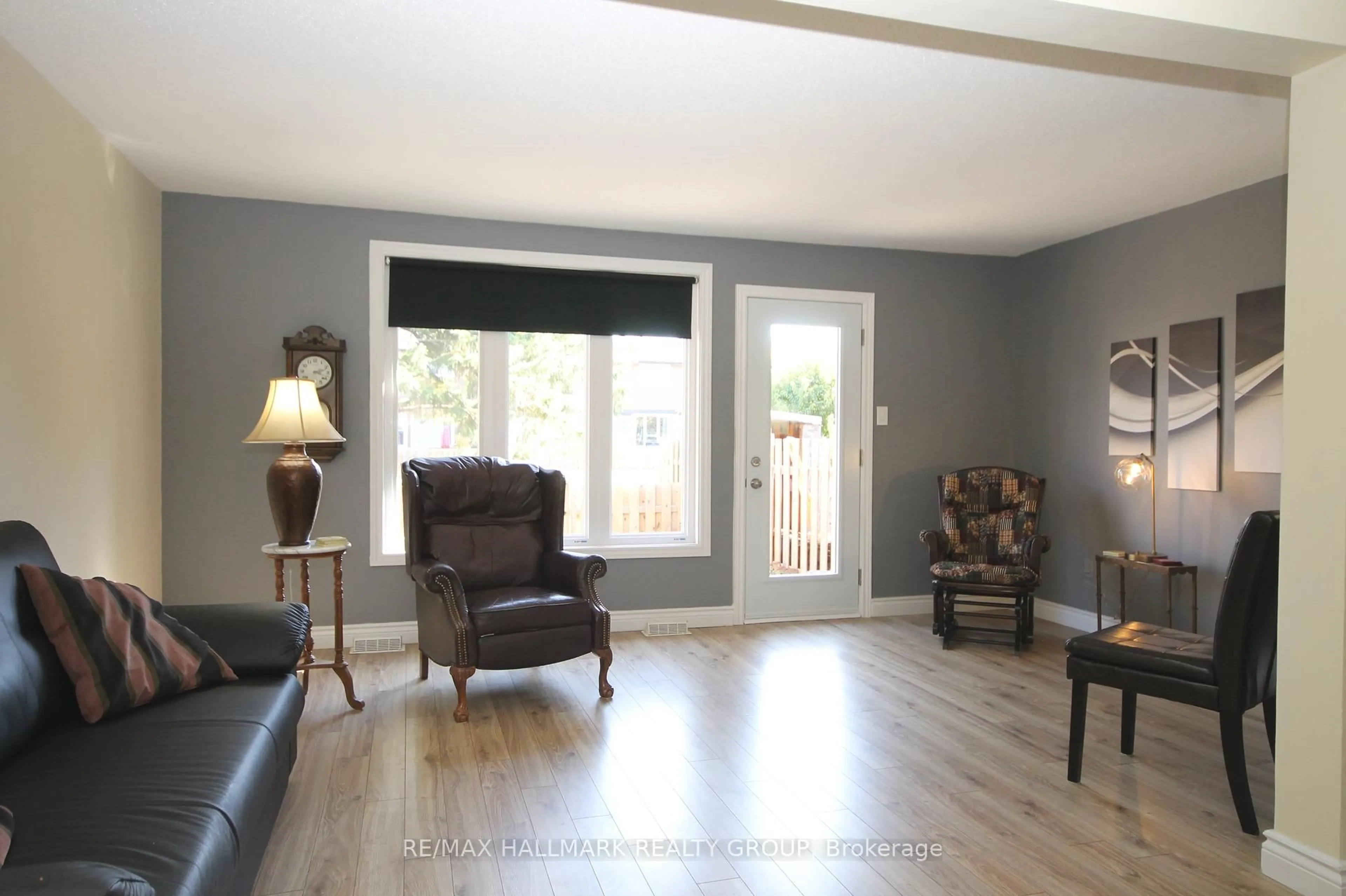 Living room with furniture, wood/laminate floor for 49 Bellman Dr, Ottawa Ontario K2H 8S4