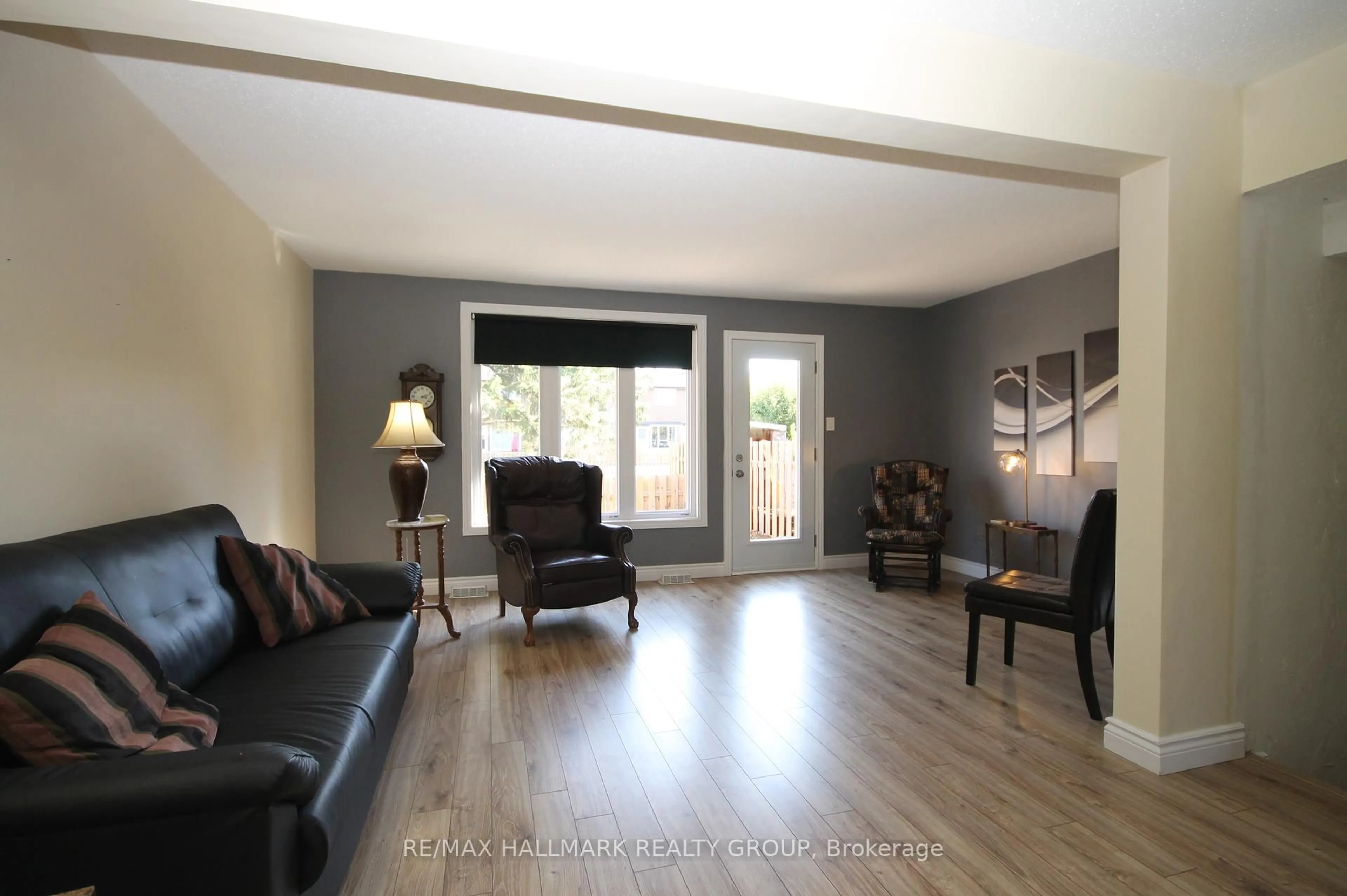 Living room with furniture, wood/laminate floor for 49 Bellman Dr, Ottawa Ontario K2H 8S4