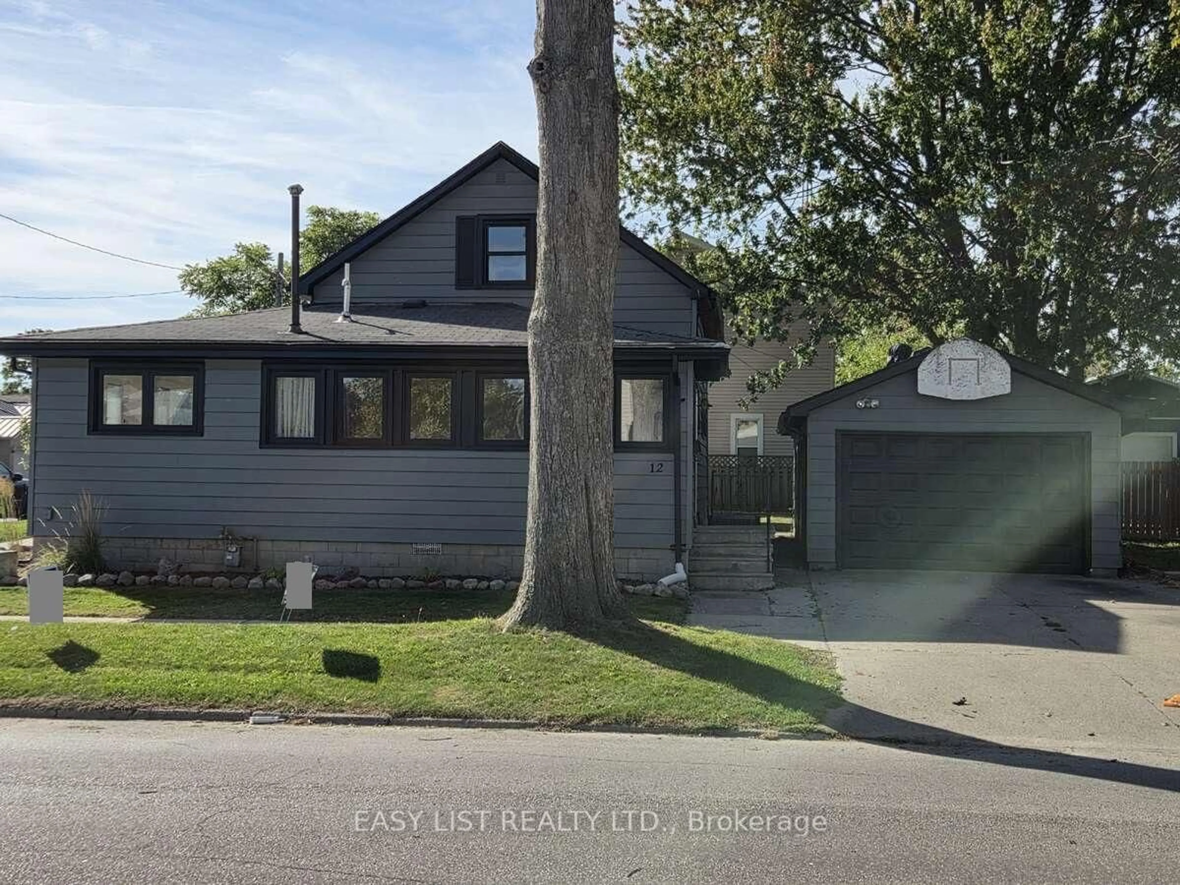 Home with vinyl exterior material, street for 12 Montgomery St, Leamington Ontario N8H 1Z9