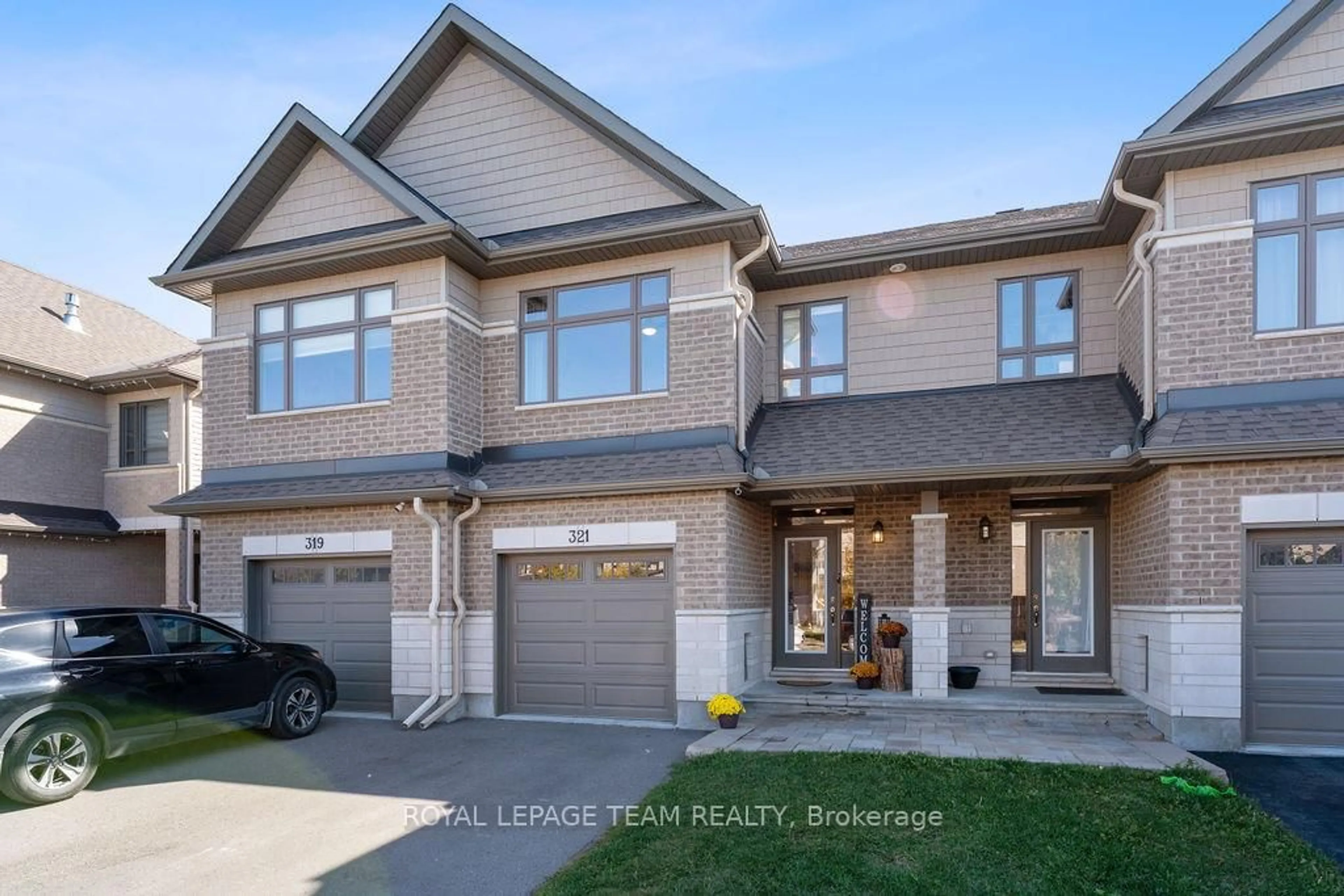 Home with brick exterior material, street for 321 Proud Walk, Stittsville Ontario K2S 2L6