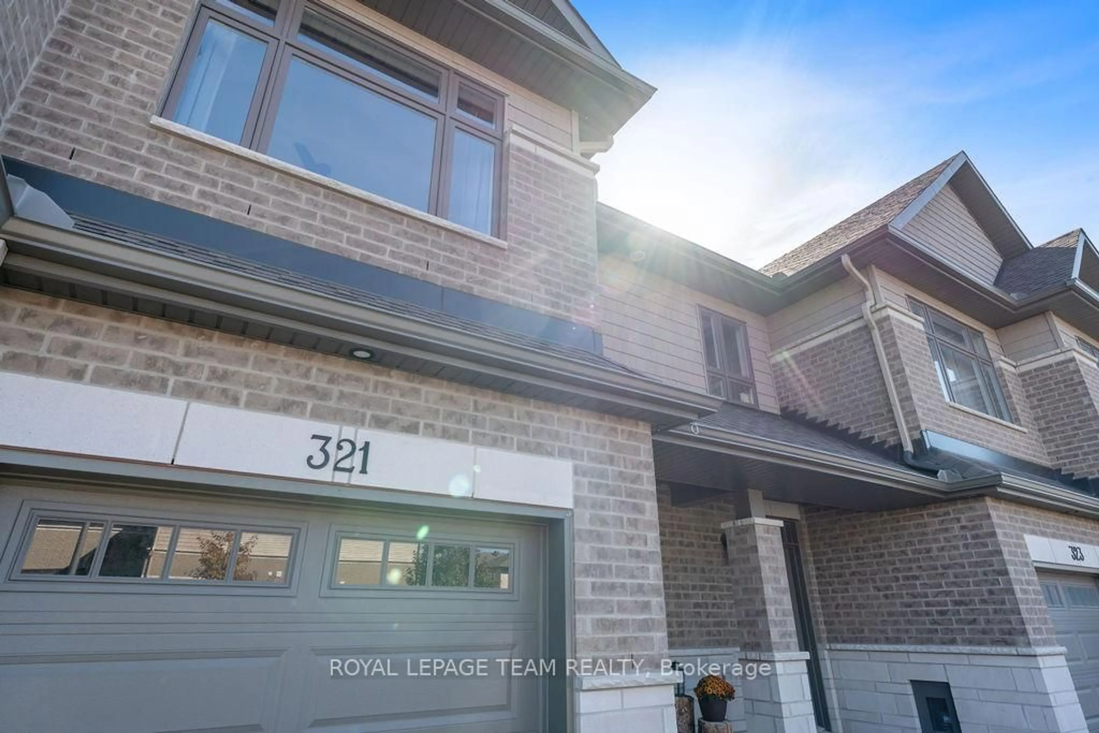 Home with brick exterior material, street for 321 Proud Walk, Stittsville Ontario K2S 2L6