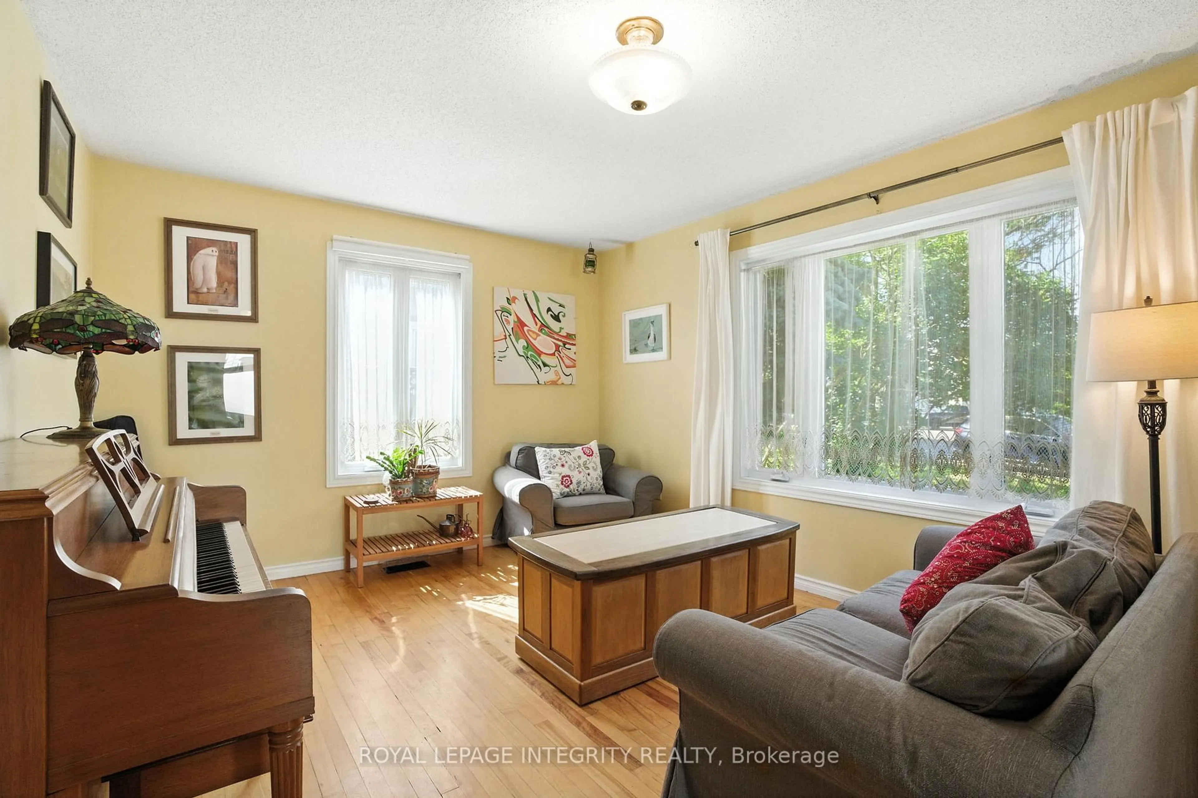 Living room with furniture, wood/laminate floor for 841 Merivale Rd, Ottawa Ontario K1Z 5Z7