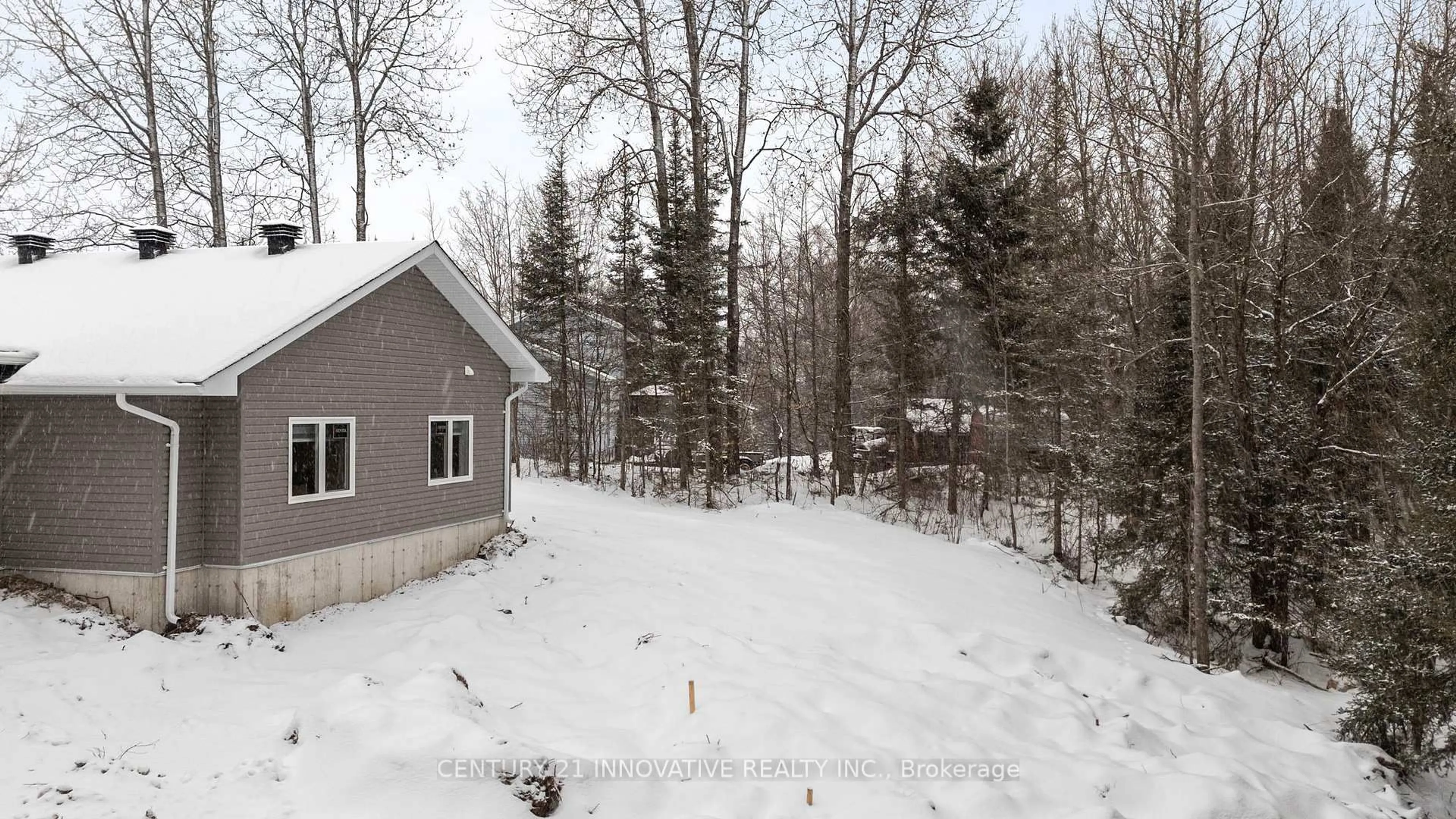 A pic from outside/outdoor area/front of a property/back of a property/a pic from drone, forest/trees view for 15 Grant Crt, South River Ontario P0A 1X0