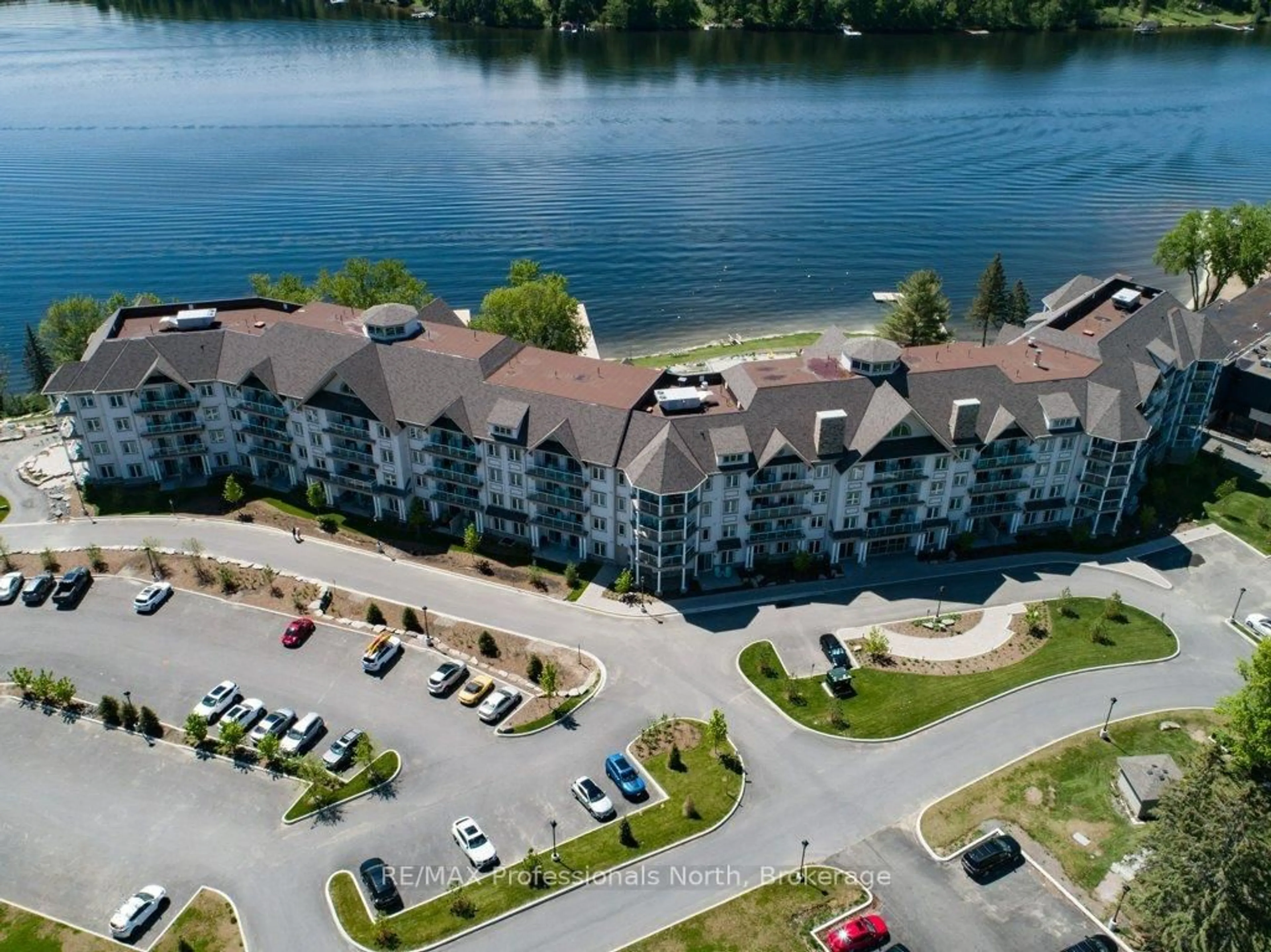 A pic from outside/outdoor area/front of a property/back of a property/a pic from drone, water/lake/river/ocean view for 25 Pen Lake Point Rd #100, Huntsville Ontario P1H 1A9