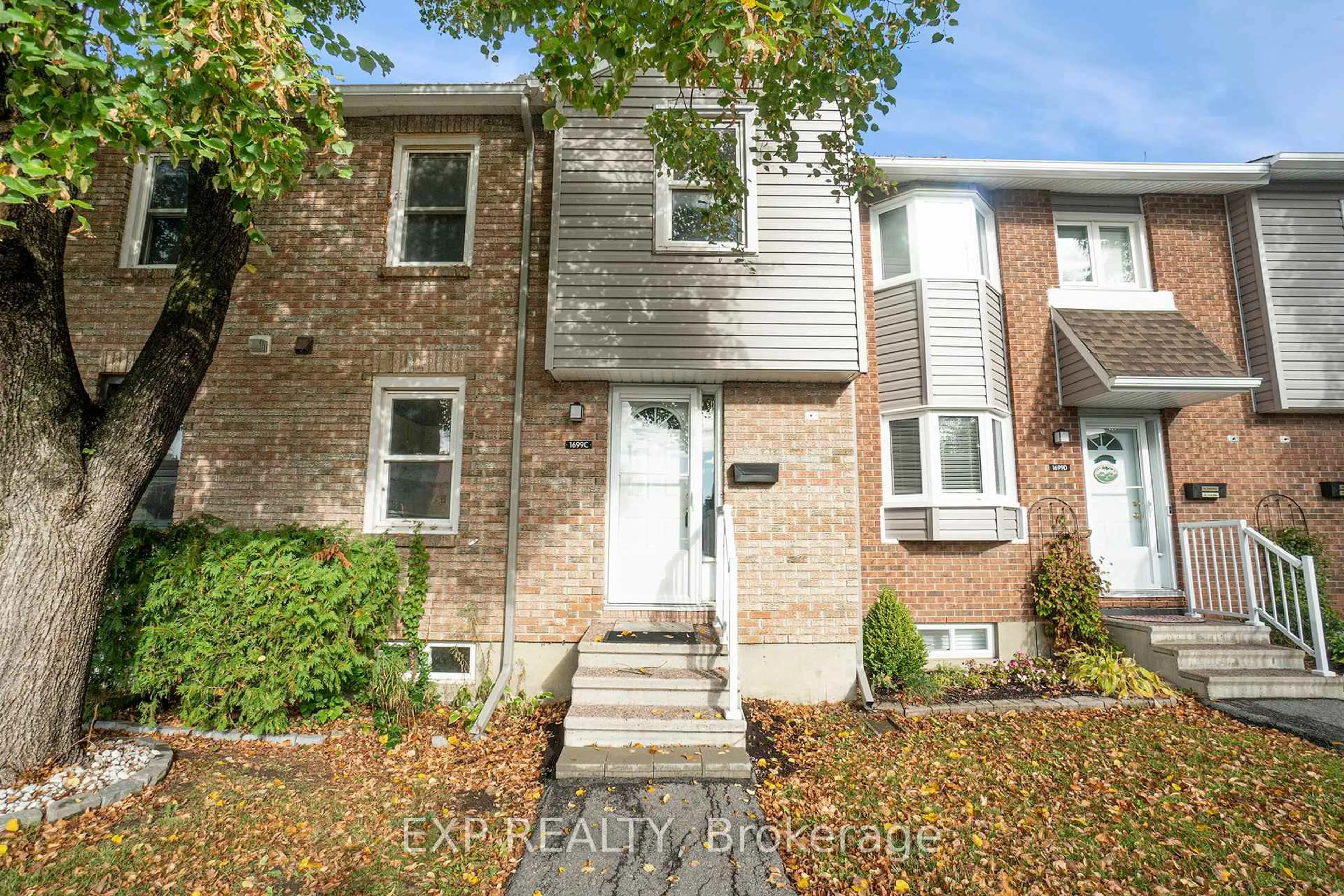 Home with brick exterior material, street for 1699C Lamoureux Dr #C, Ottawa Ontario K1E 2N3