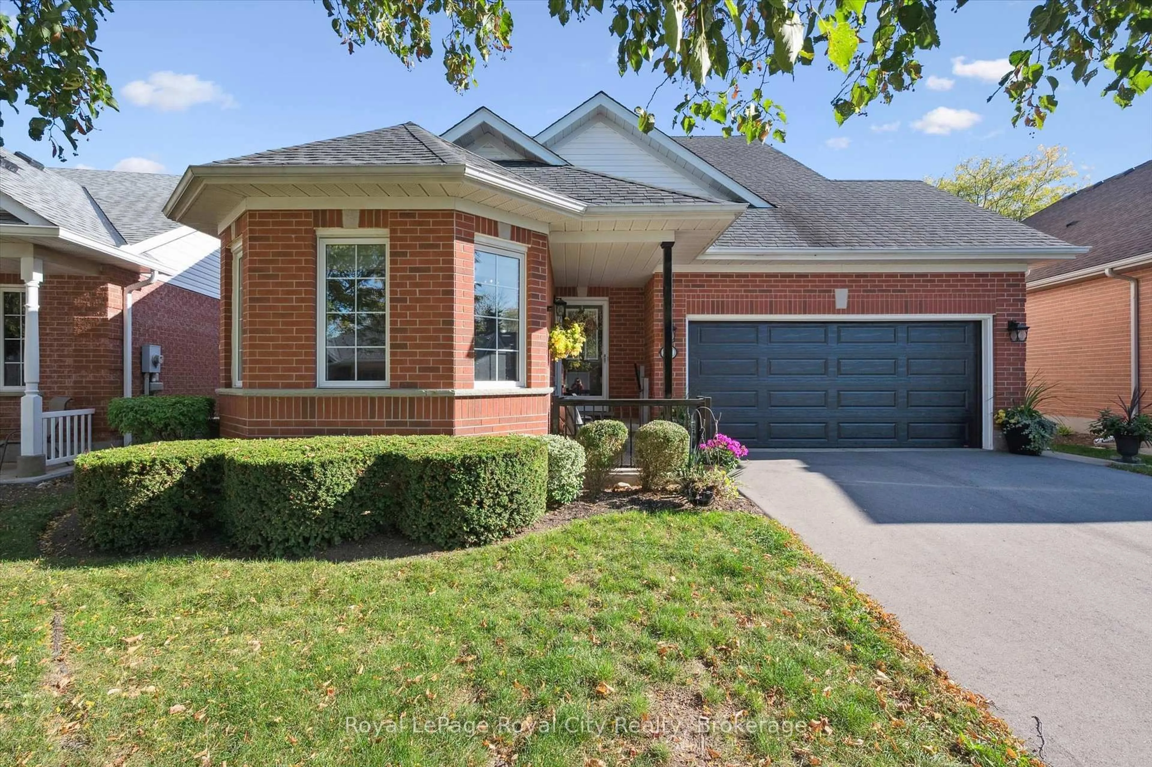Home with brick exterior material, street for 21 Cherry Blossom Circ, Guelph Ontario N1G 4X7