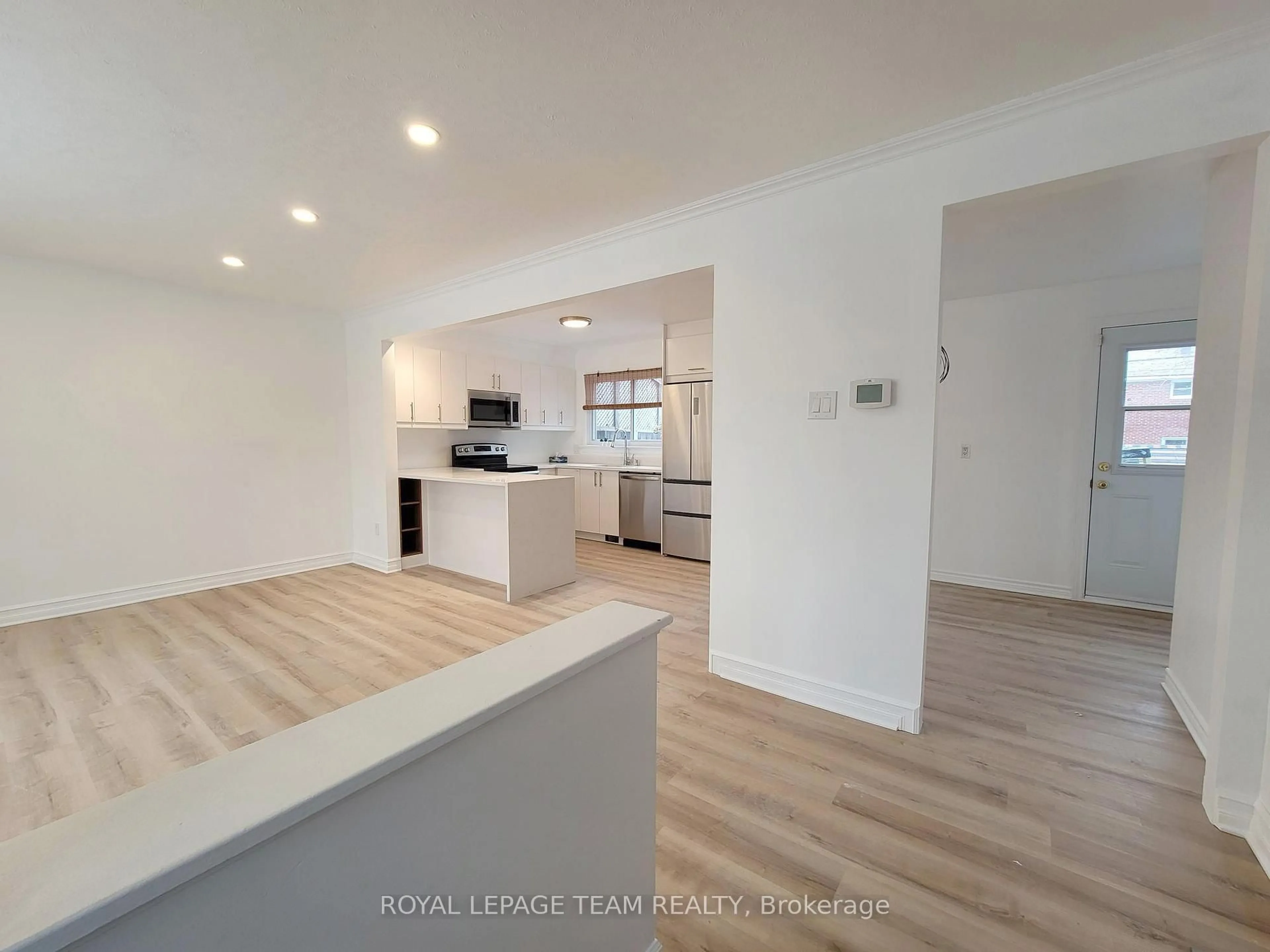 Open concept kitchen, wood/laminate floor for 852 Cummings Ave, Ottawa Ontario K1K 2L4