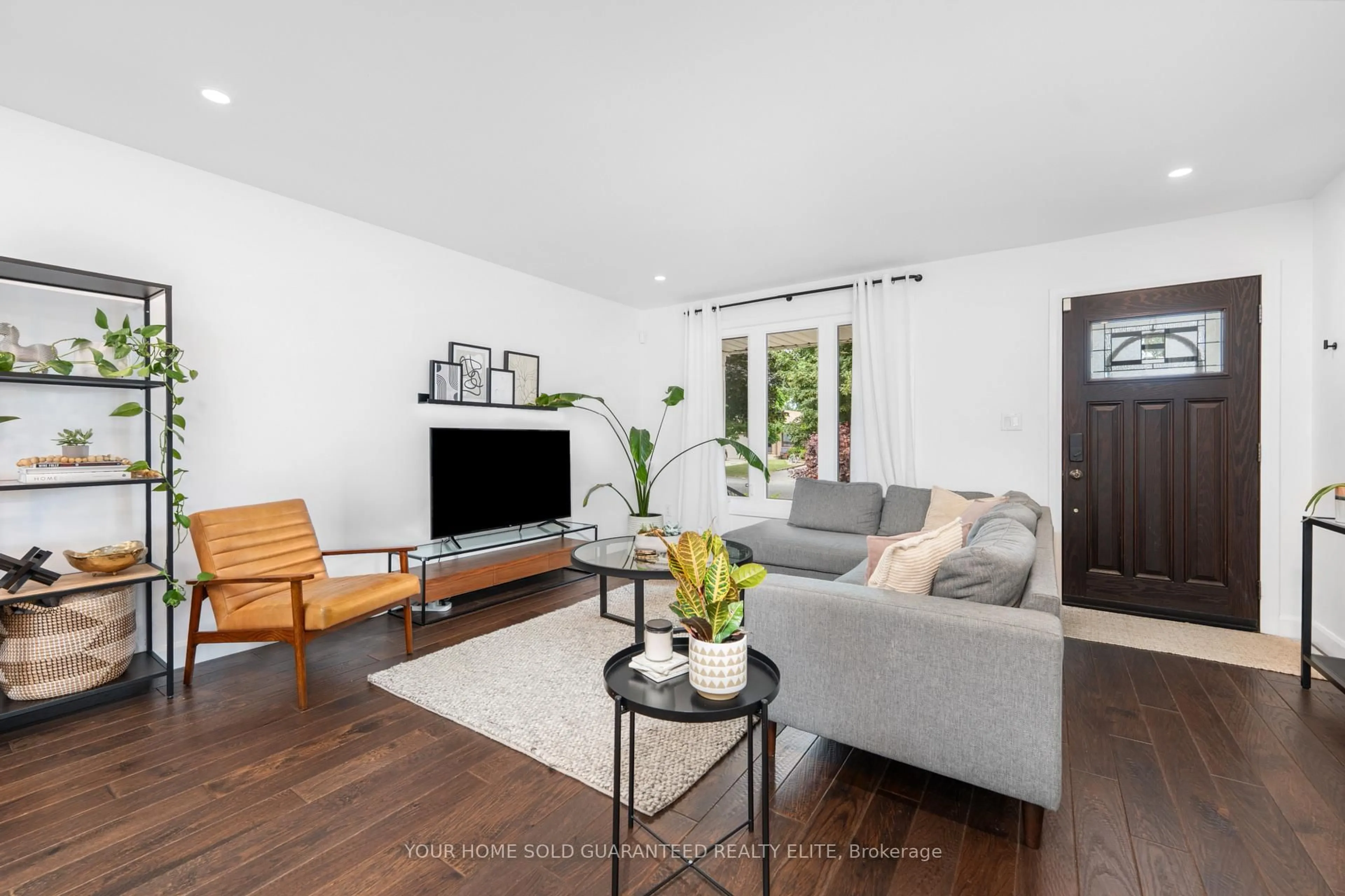 Living room with furniture, wood/laminate floor for 57 Sandra Cres, Grimsby Ontario L3M 4Y5