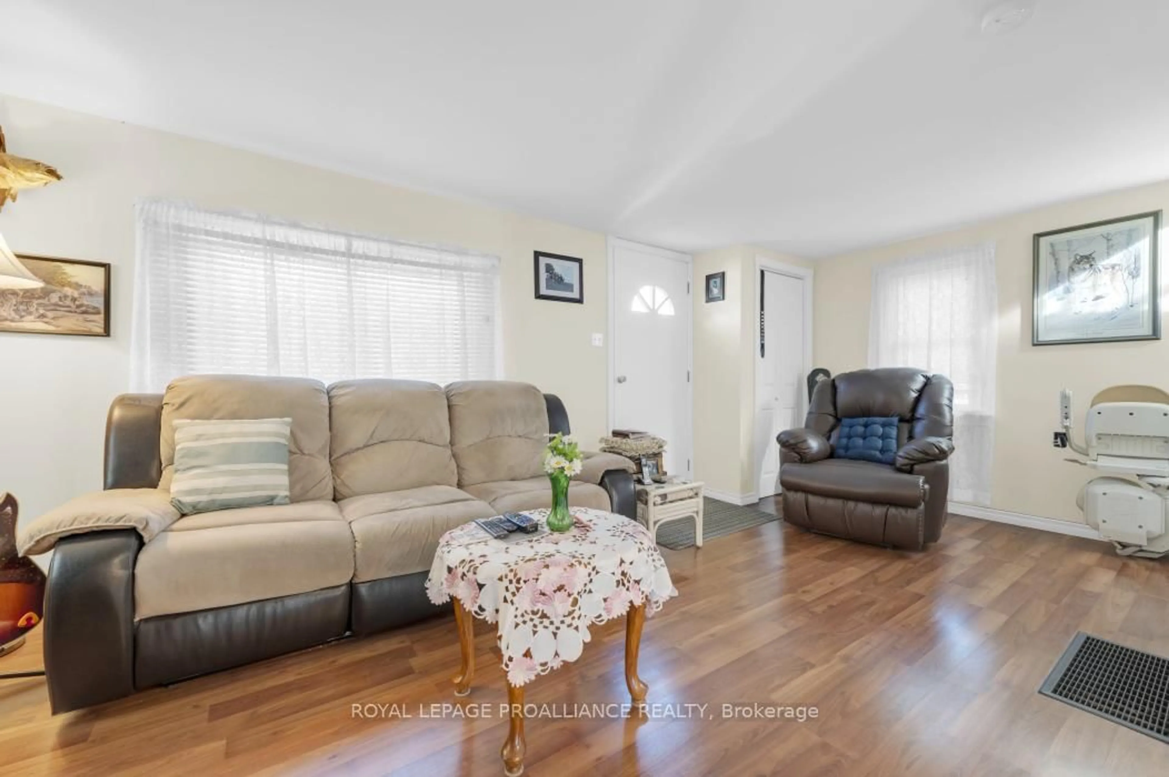 Living room with furniture, wood/laminate floor for 36 Jones St, Kaladar Ontario K0H 1P0