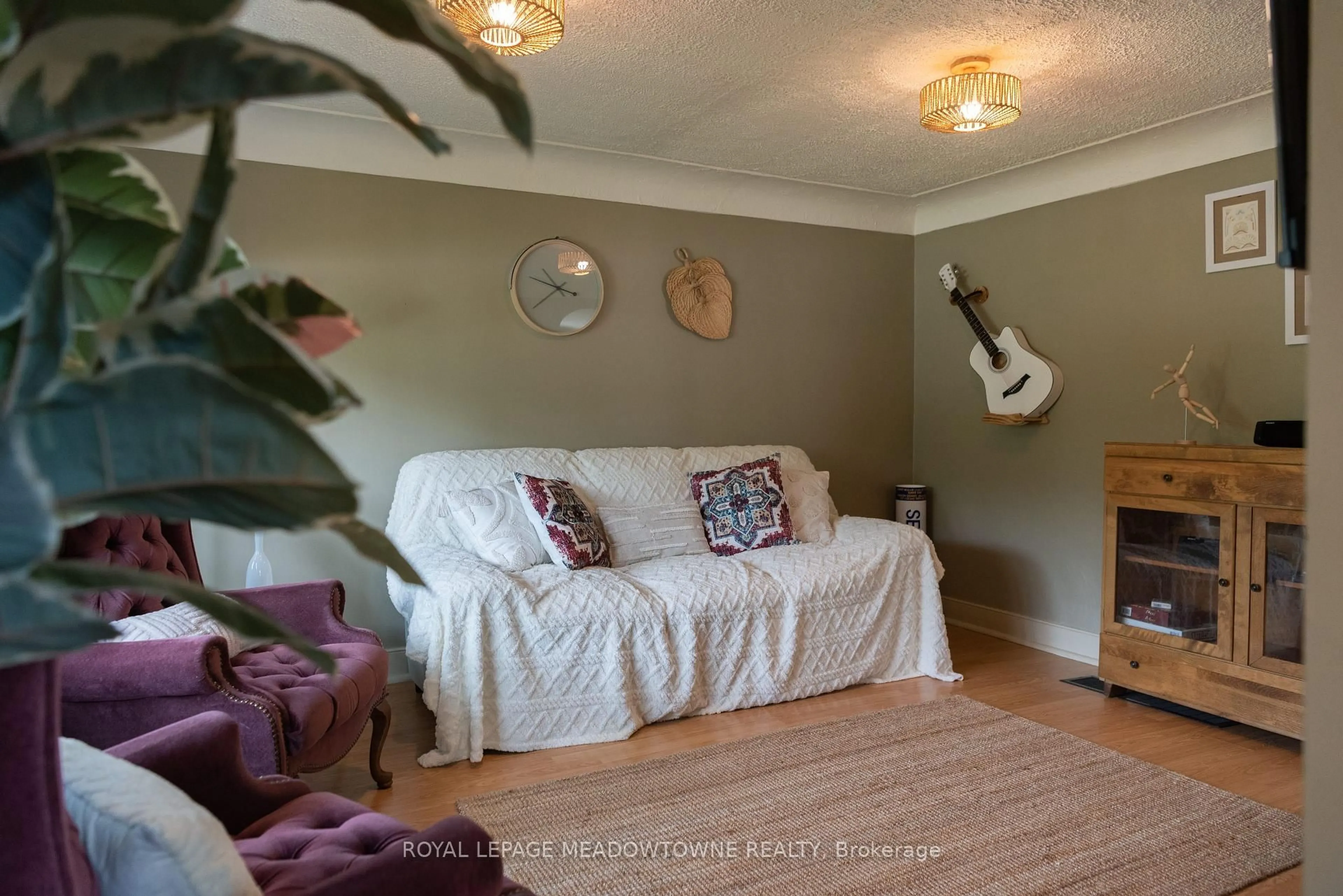 Living room with furniture, wood/laminate floor for 5853 Mcleod Rd, Niagara Falls Ontario L2G 3E5