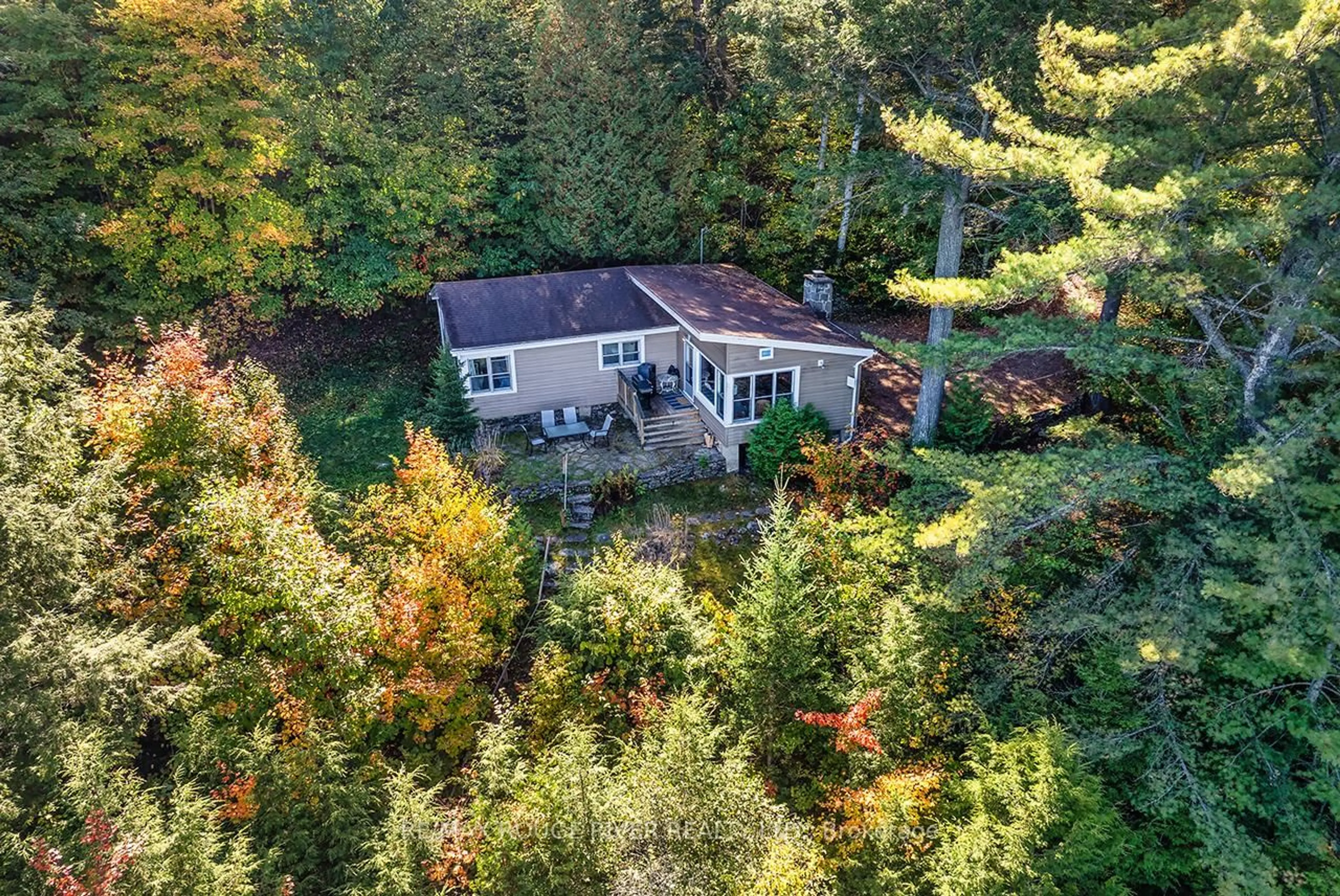 A pic from outside/outdoor area/front of a property/back of a property/a pic from drone, forest/trees view for 5031 Muskoka Road 117 Highway, Lake of Bays Ontario P0A 1E0