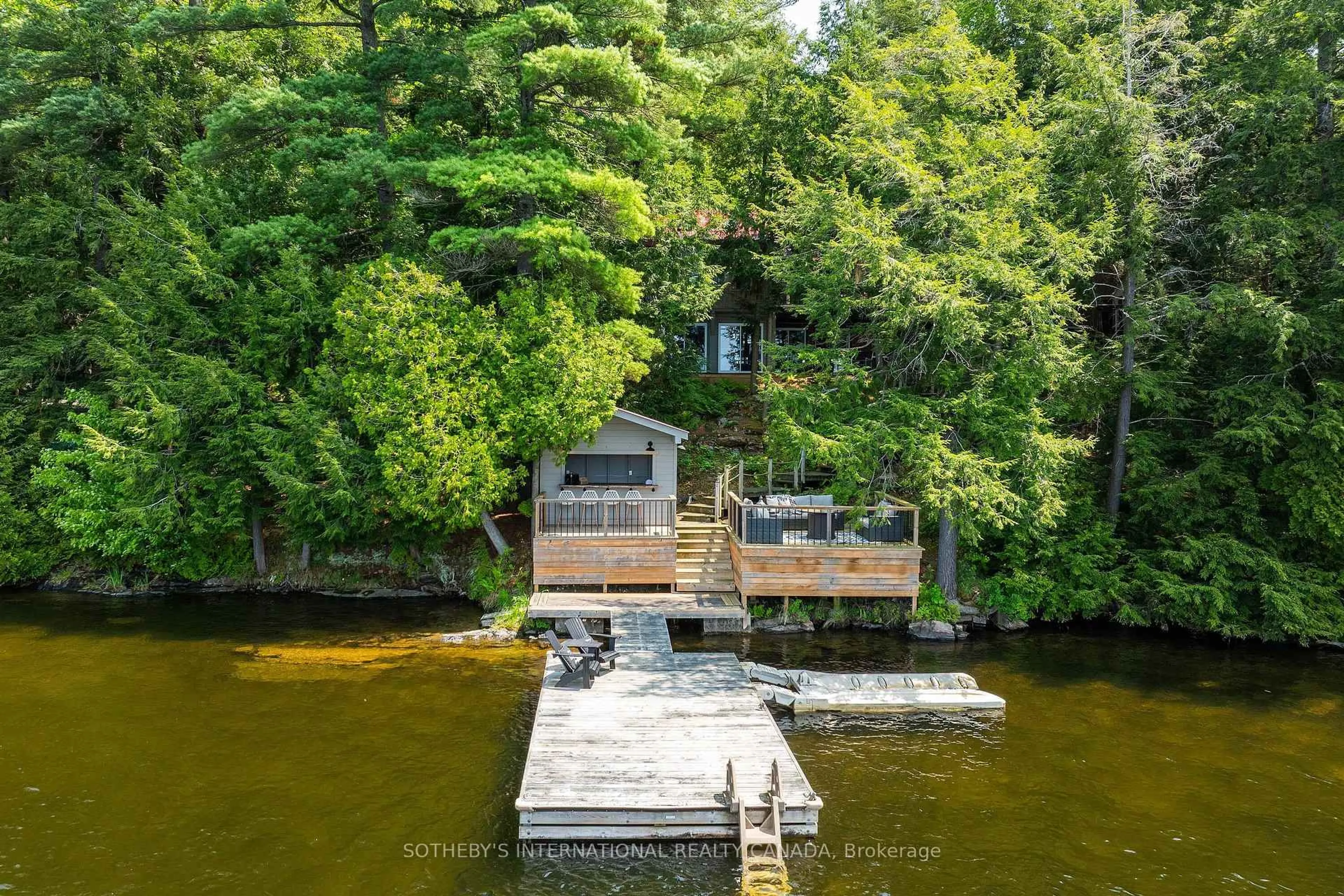 A pic from outside/outdoor area/front of a property/back of a property/a pic from drone, water/lake/river/ocean view for 1050 Cobble Rose Lane, Minden Hills Ontario K0M 2L1