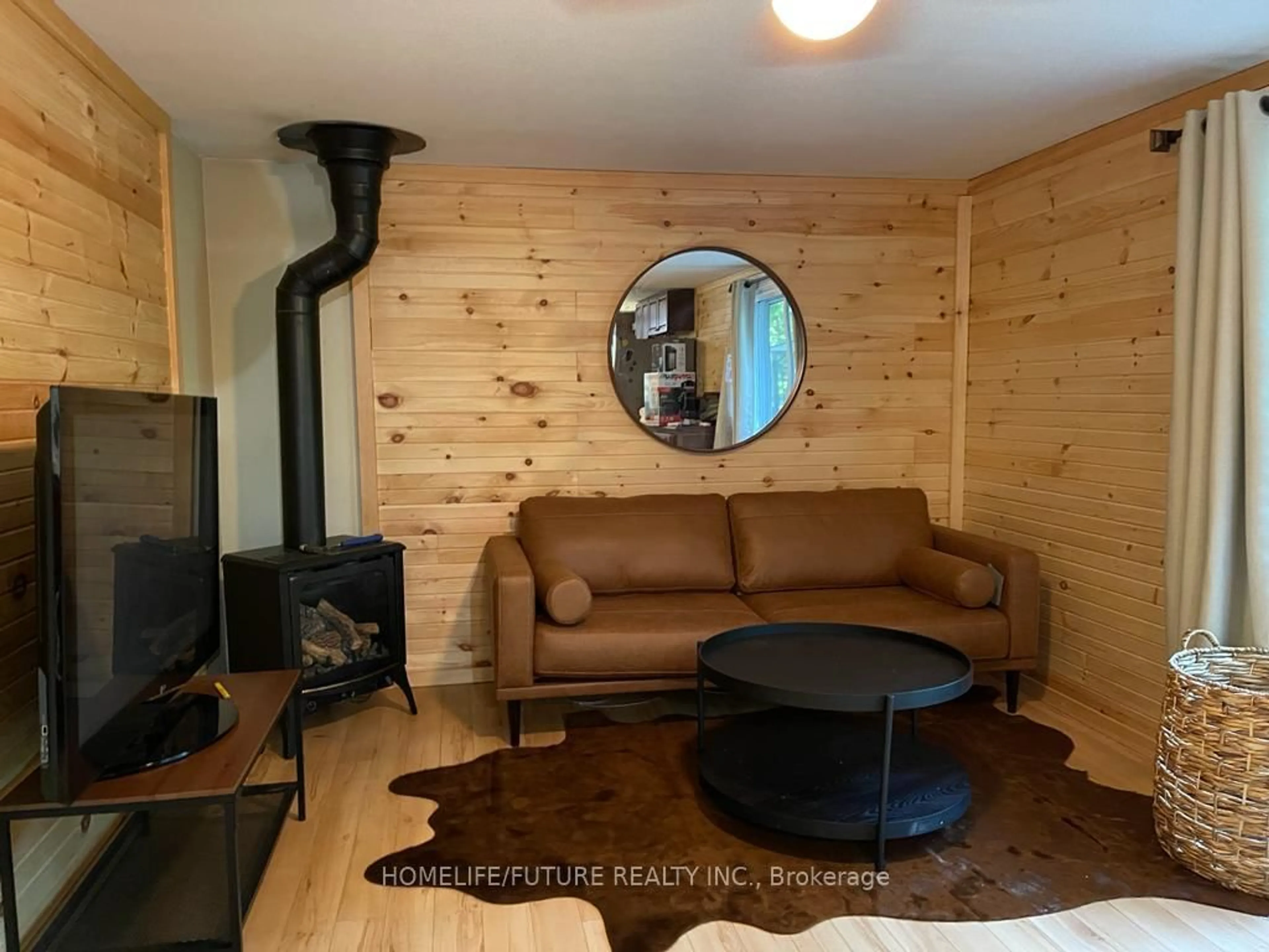 Living room with furniture, wood/laminate floor for 179 Stanley Rd, Kawartha Lakes Ontario K0M 2T0