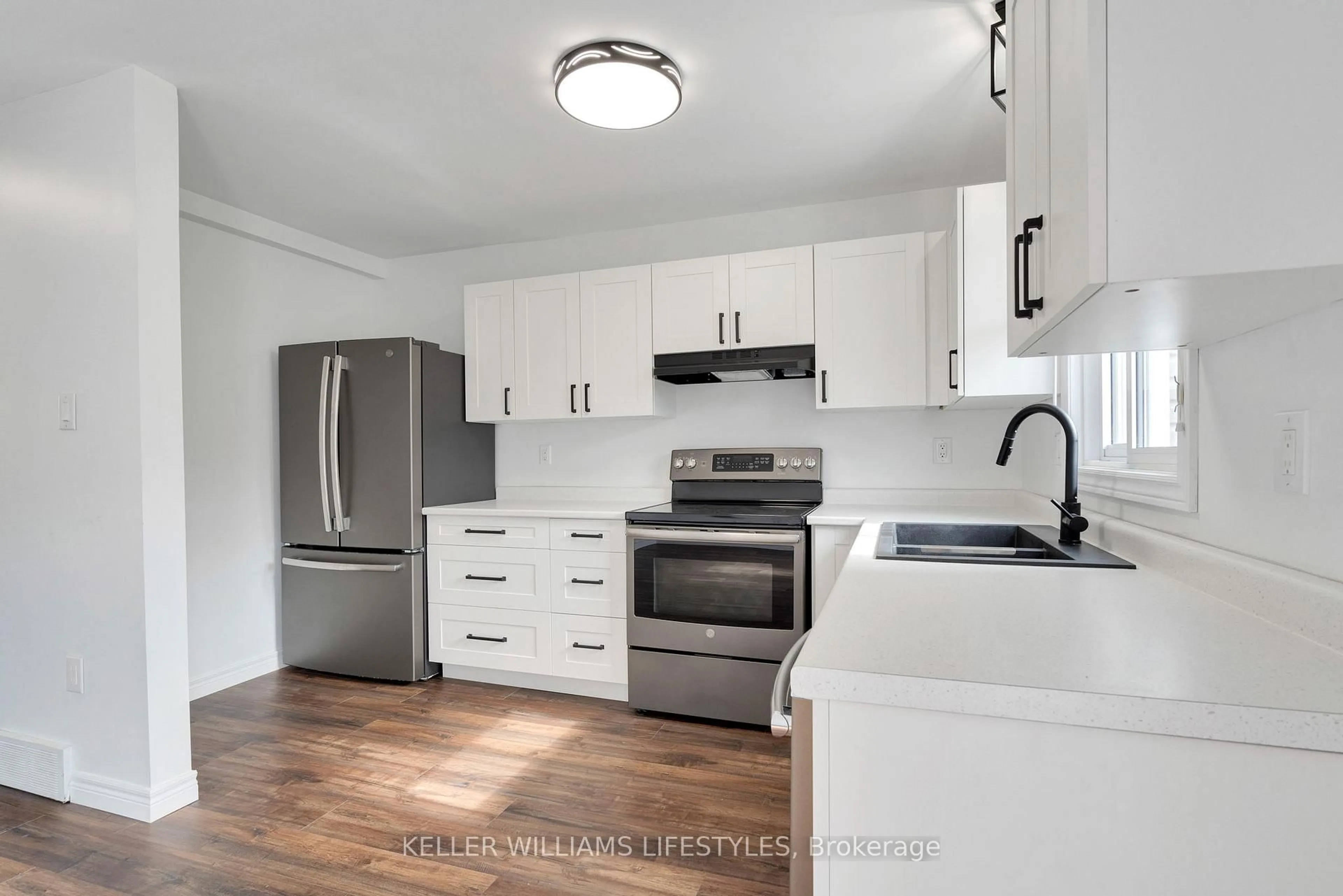 Open concept kitchen, wood/laminate floor for 301 Carlow Rd #41, Central Elgin Ontario N5L 1B8