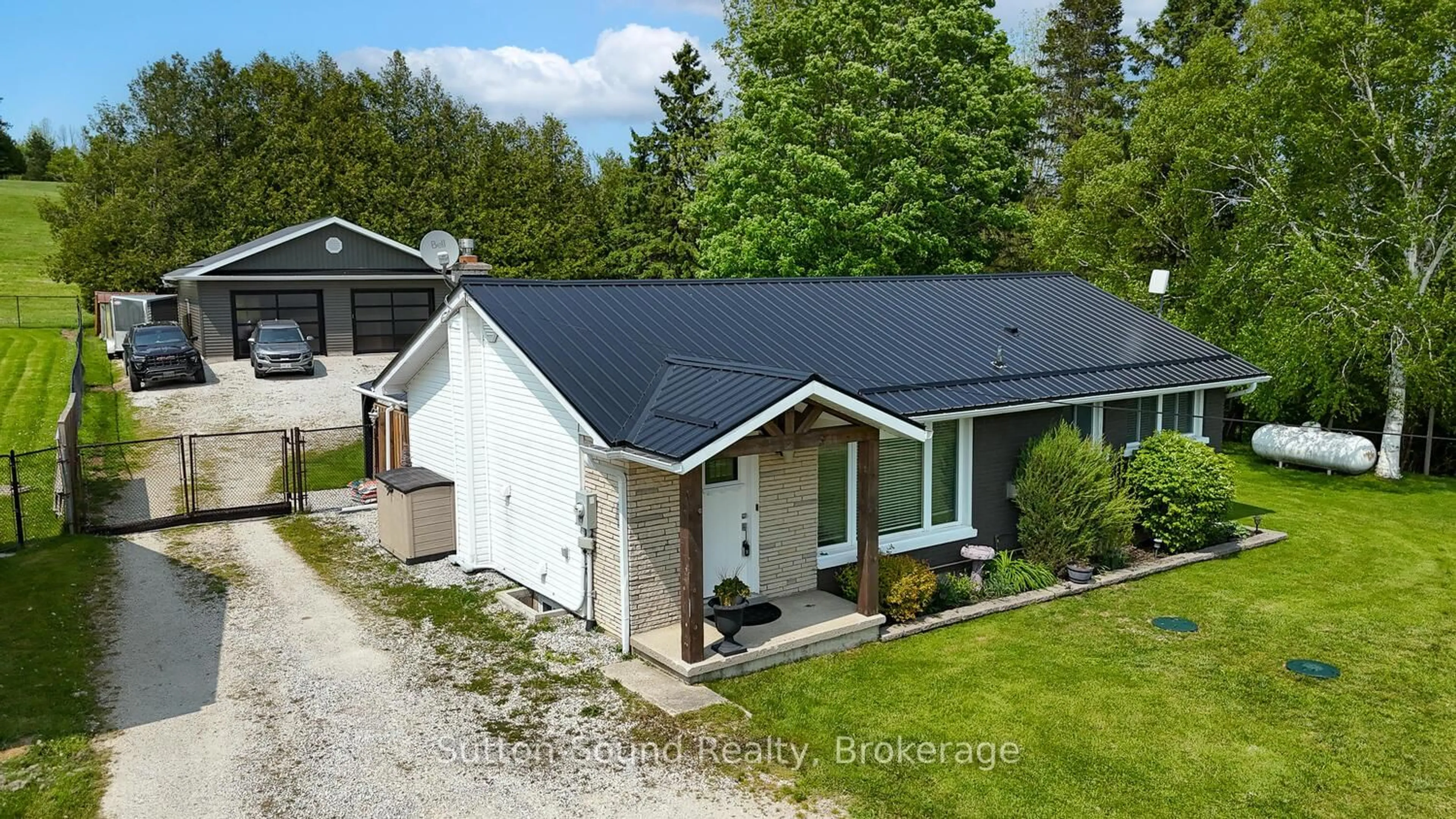 A pic from outside/outdoor area/front of a property/back of a property/a pic from drone, unknown for 202093 21 Highway, Georgian Bluffs Ontario N4K 5N7