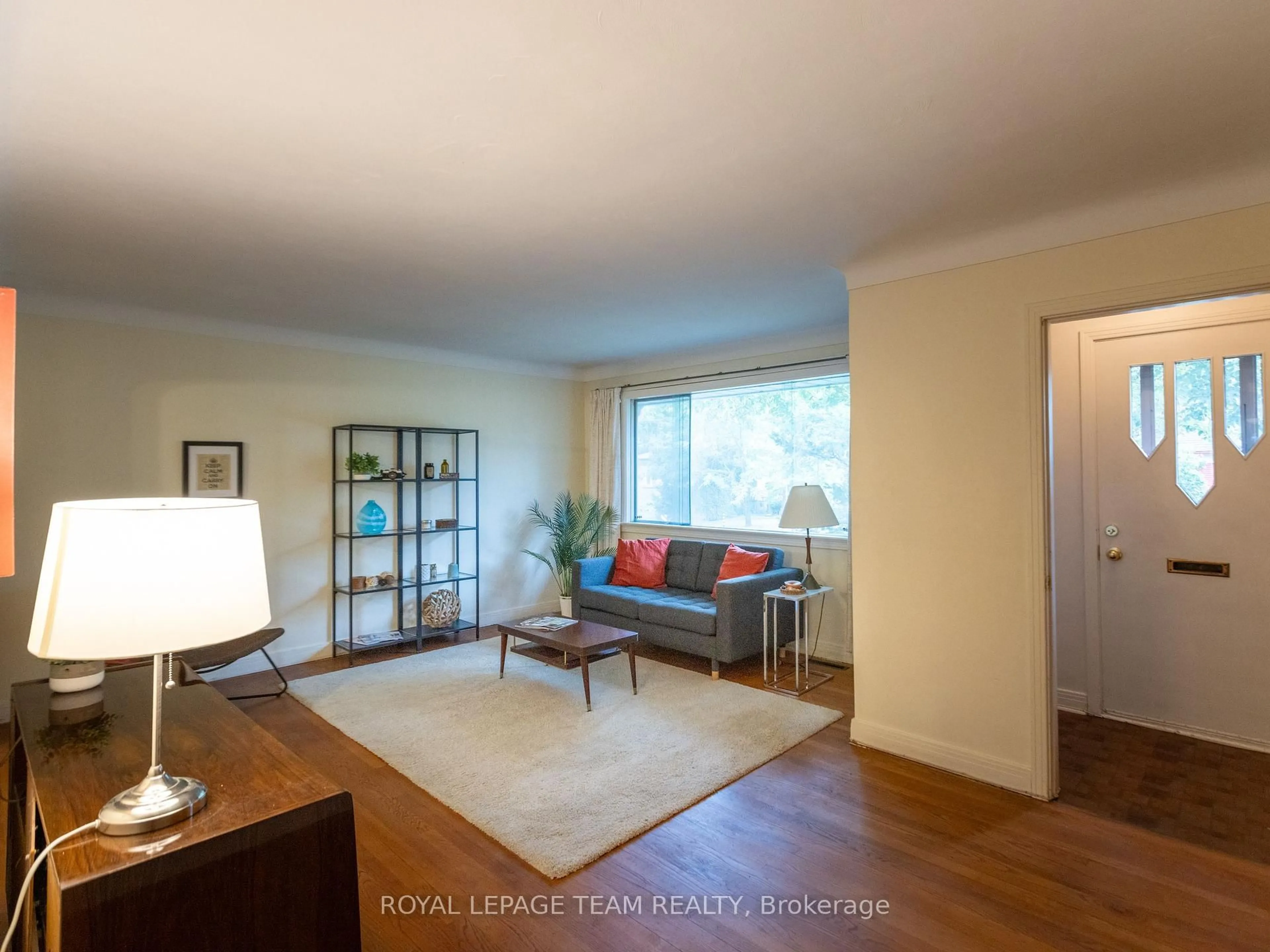 Living room with furniture, wood/laminate floor for 1231 Ridgemont Ave, Ottawa Ontario K1V 6E6