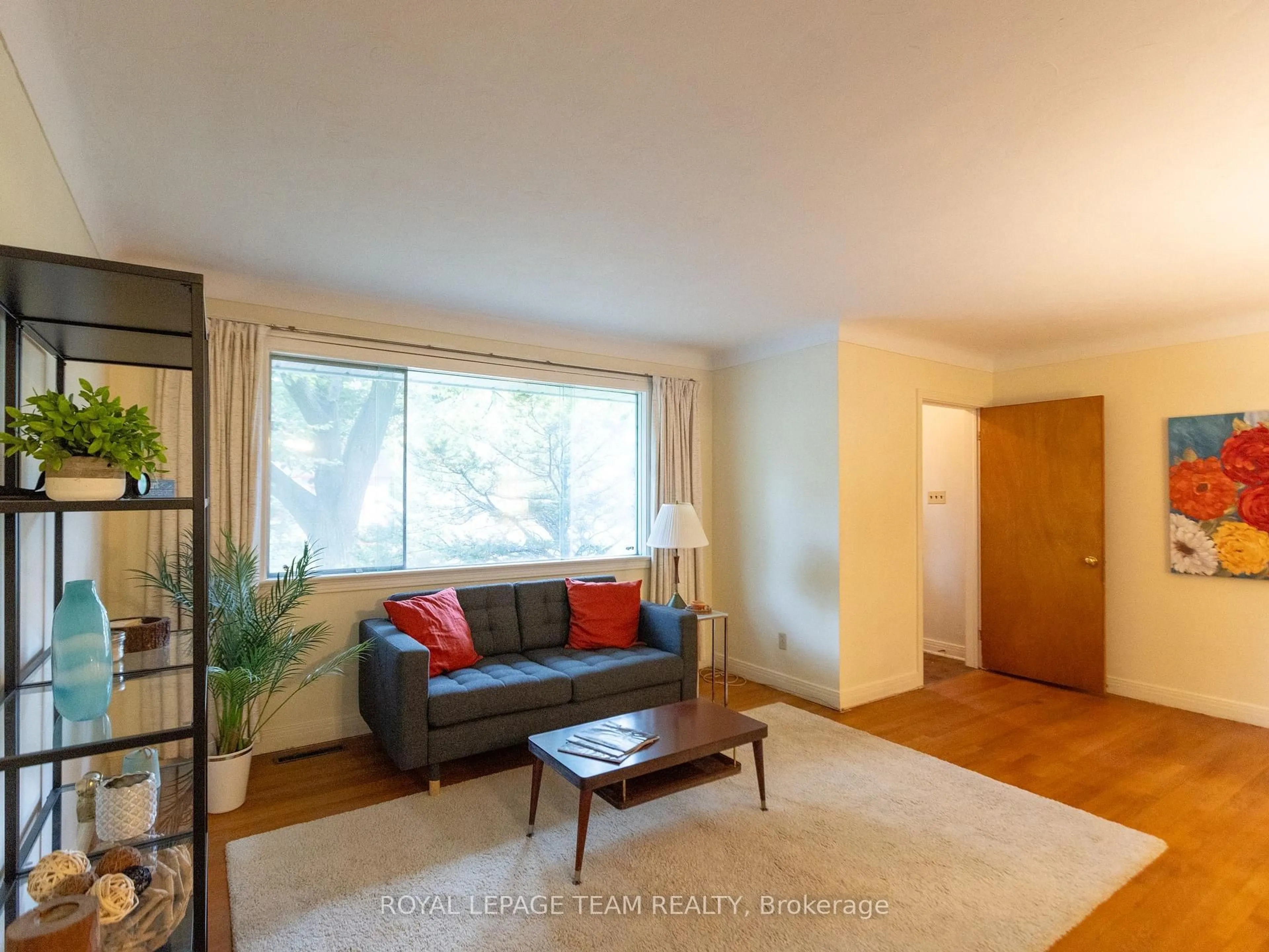 Living room with furniture, wood/laminate floor for 1231 Ridgemont Ave, Ottawa Ontario K1V 6E6