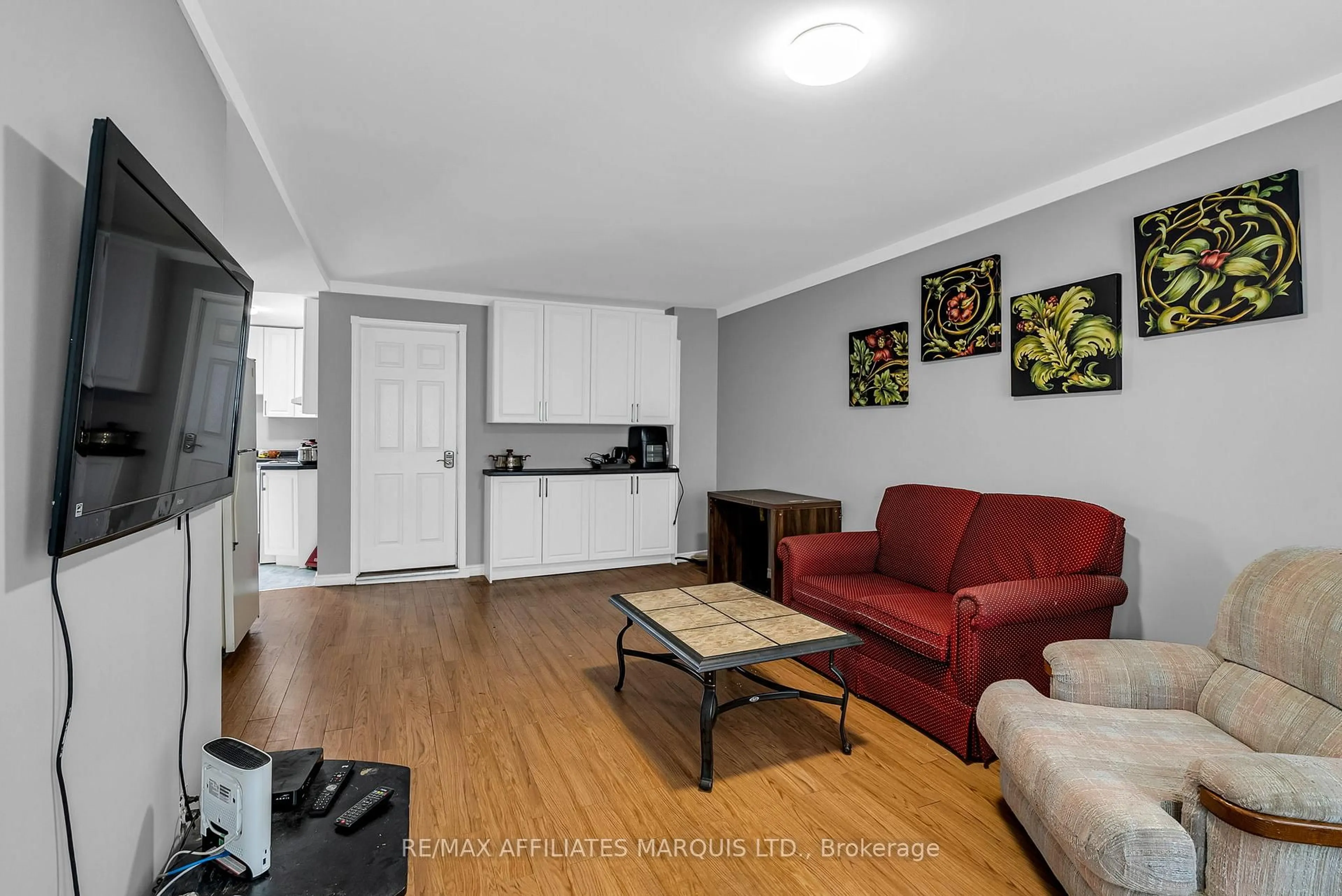 Living room with furniture, wood/laminate floor for 303 Guy St, Cornwall Ontario K6H 4V3