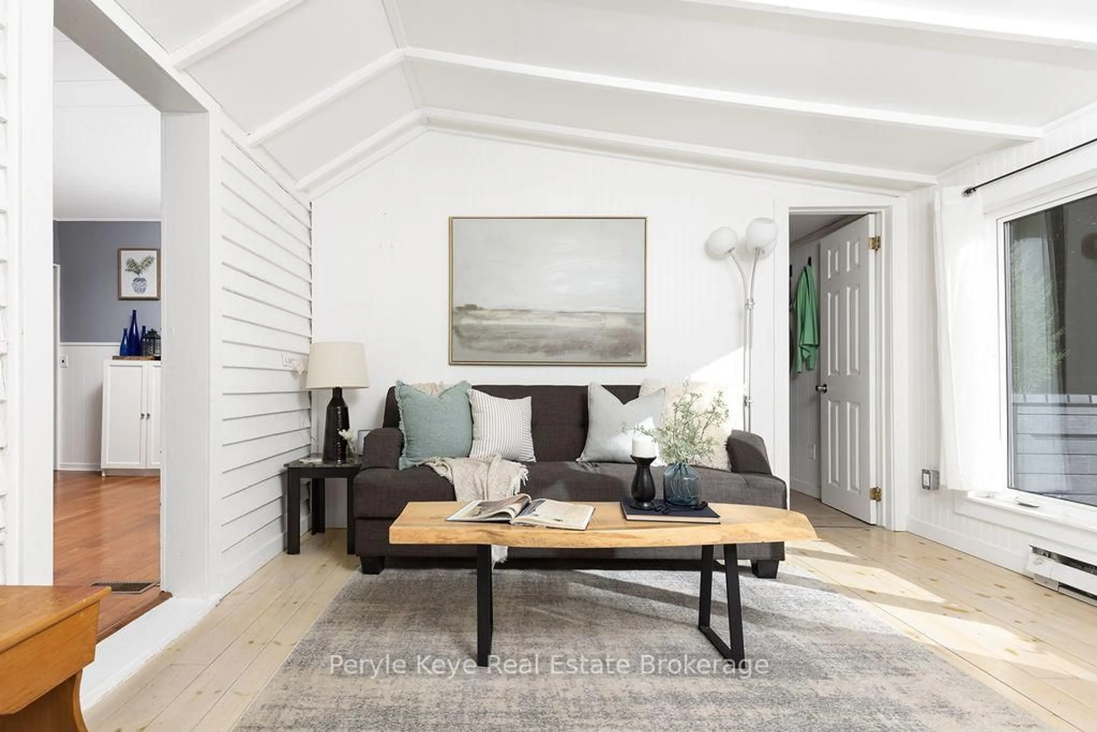 Living room with furniture, wood/laminate floor for 71 Deer Lake Rd, Huntsville Ontario P0B 1L0
