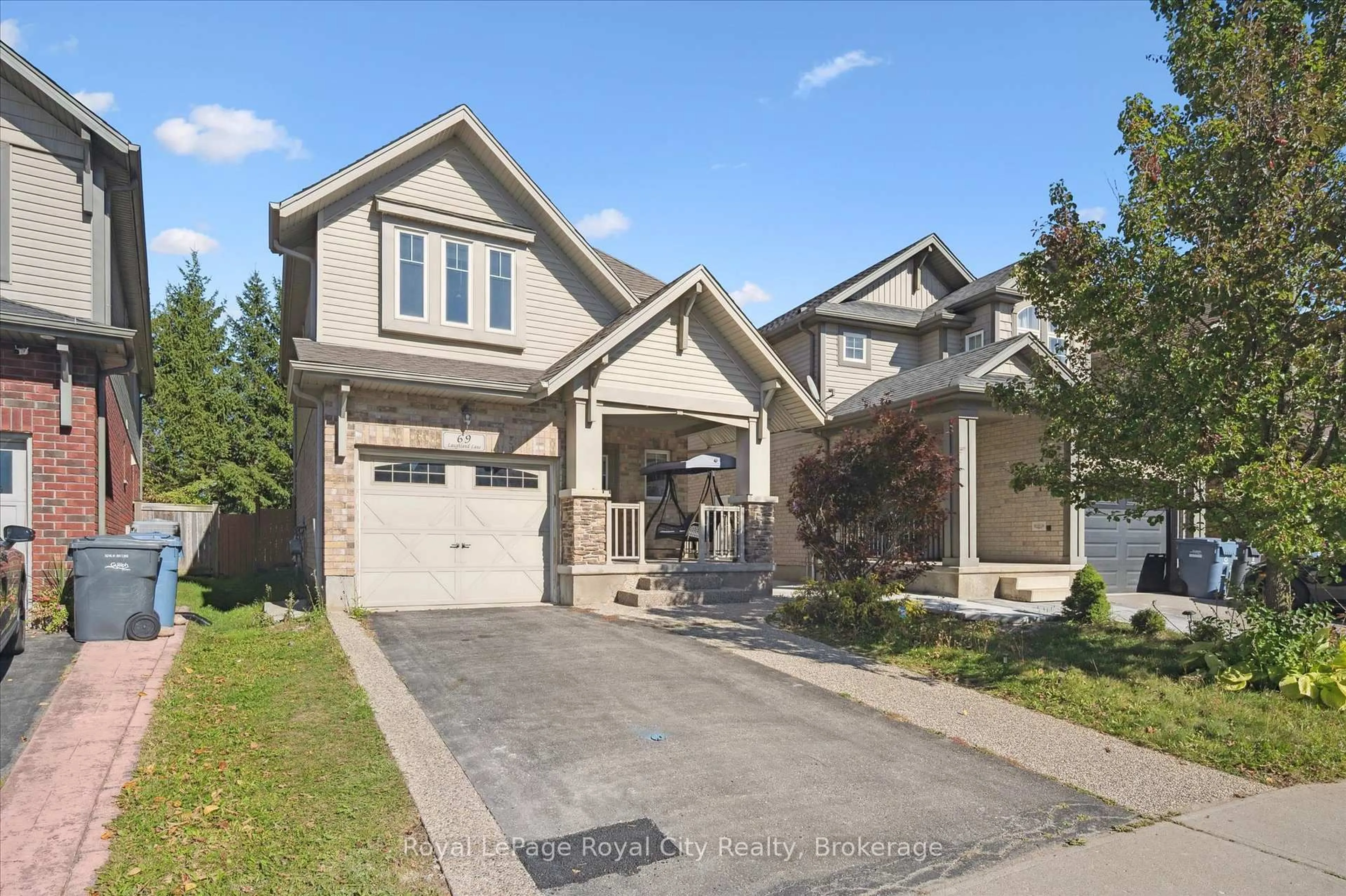 Home with brick exterior material, street for 69 Laughland Lane, Guelph Ontario N1L 0C6