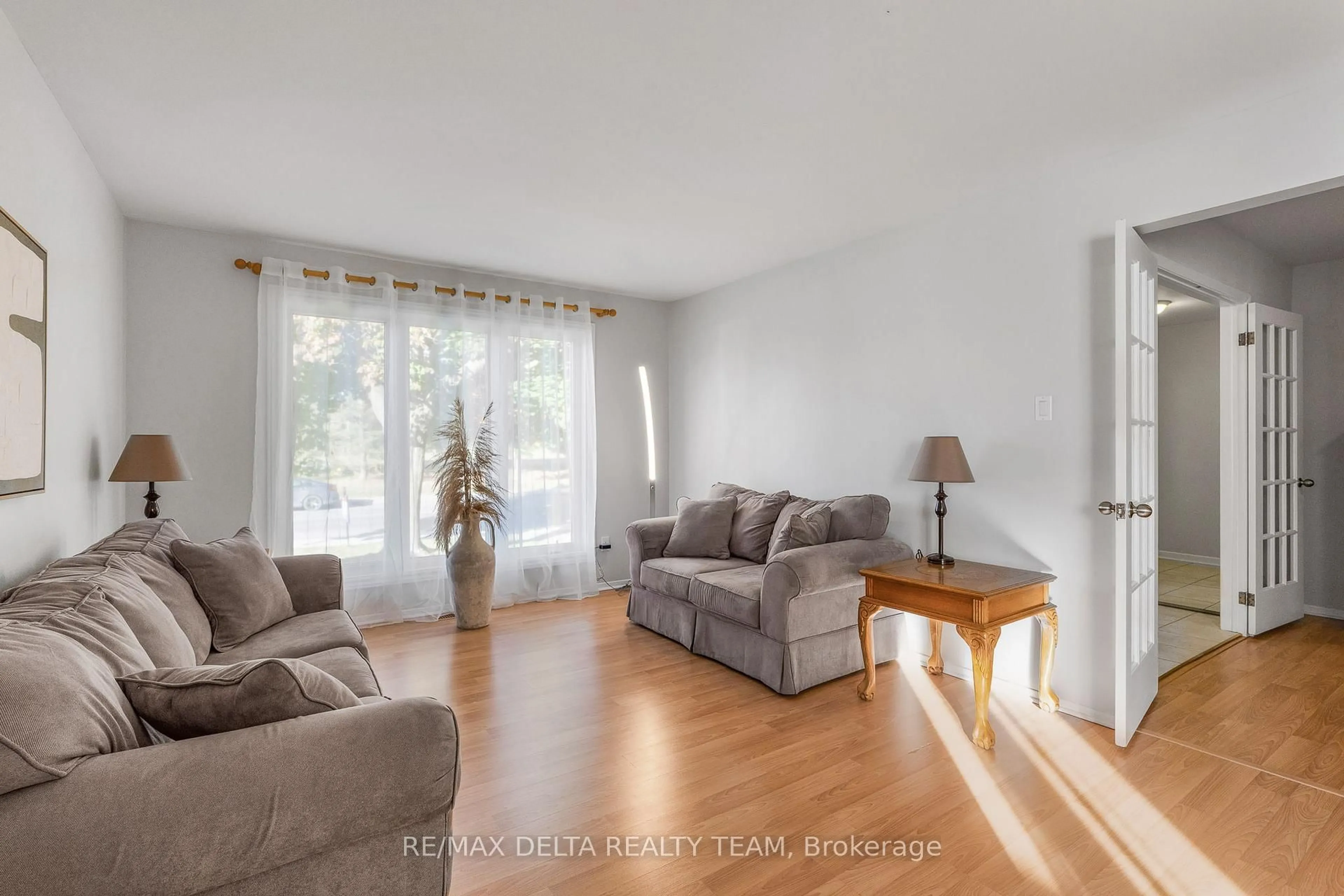Living room with furniture, wood/laminate floor for 1657 Bottriell Way, Orleans Ontario K4A 1W1