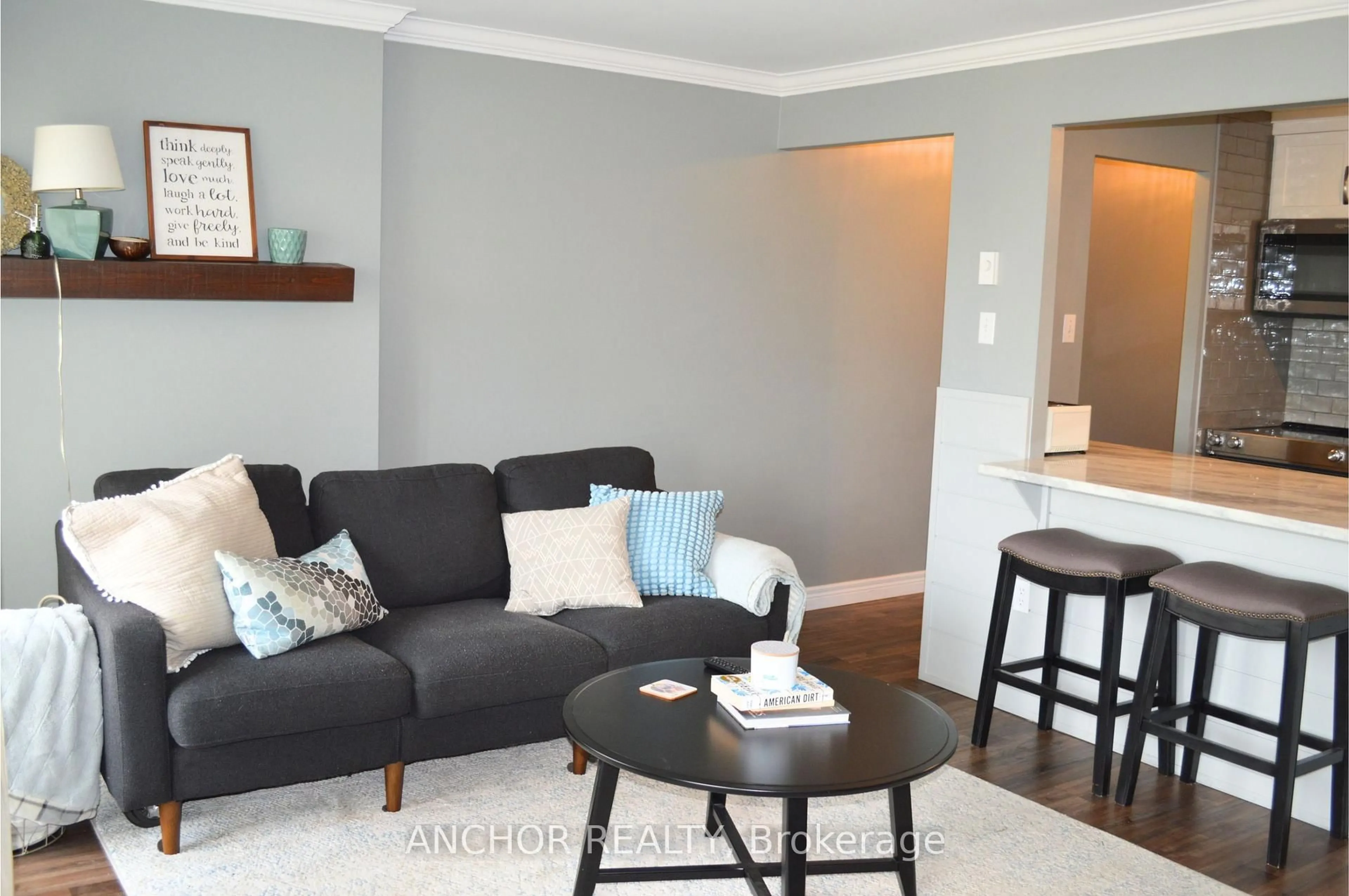 Living room with furniture, wood/laminate floor for 333 Commissioners Rd #903, London South Ontario N6J 4X7