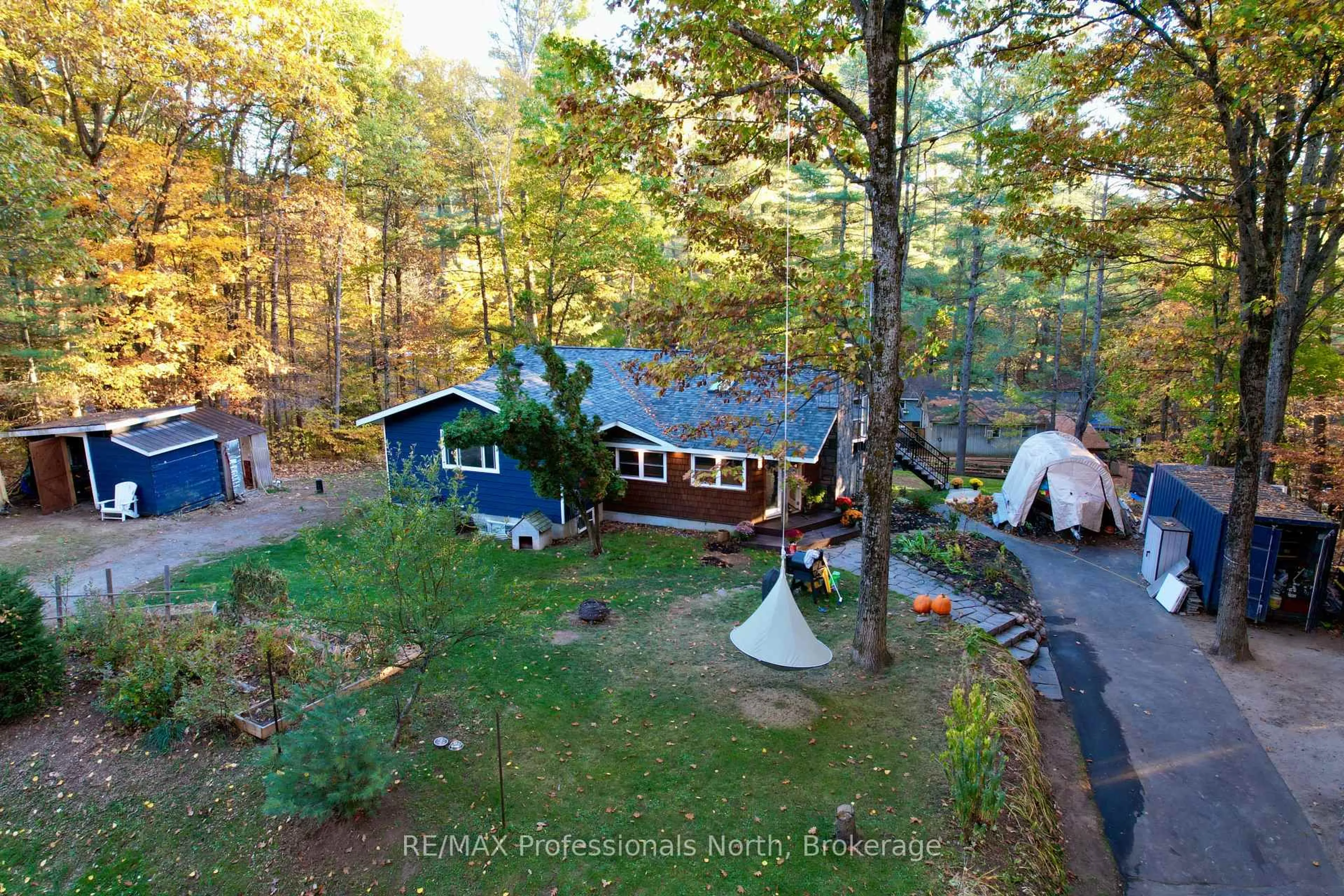 A pic from outside/outdoor area/front of a property/back of a property/a pic from drone, forest/trees view for 31 Falls View Rd, Huntsville Ontario P0B 1L0