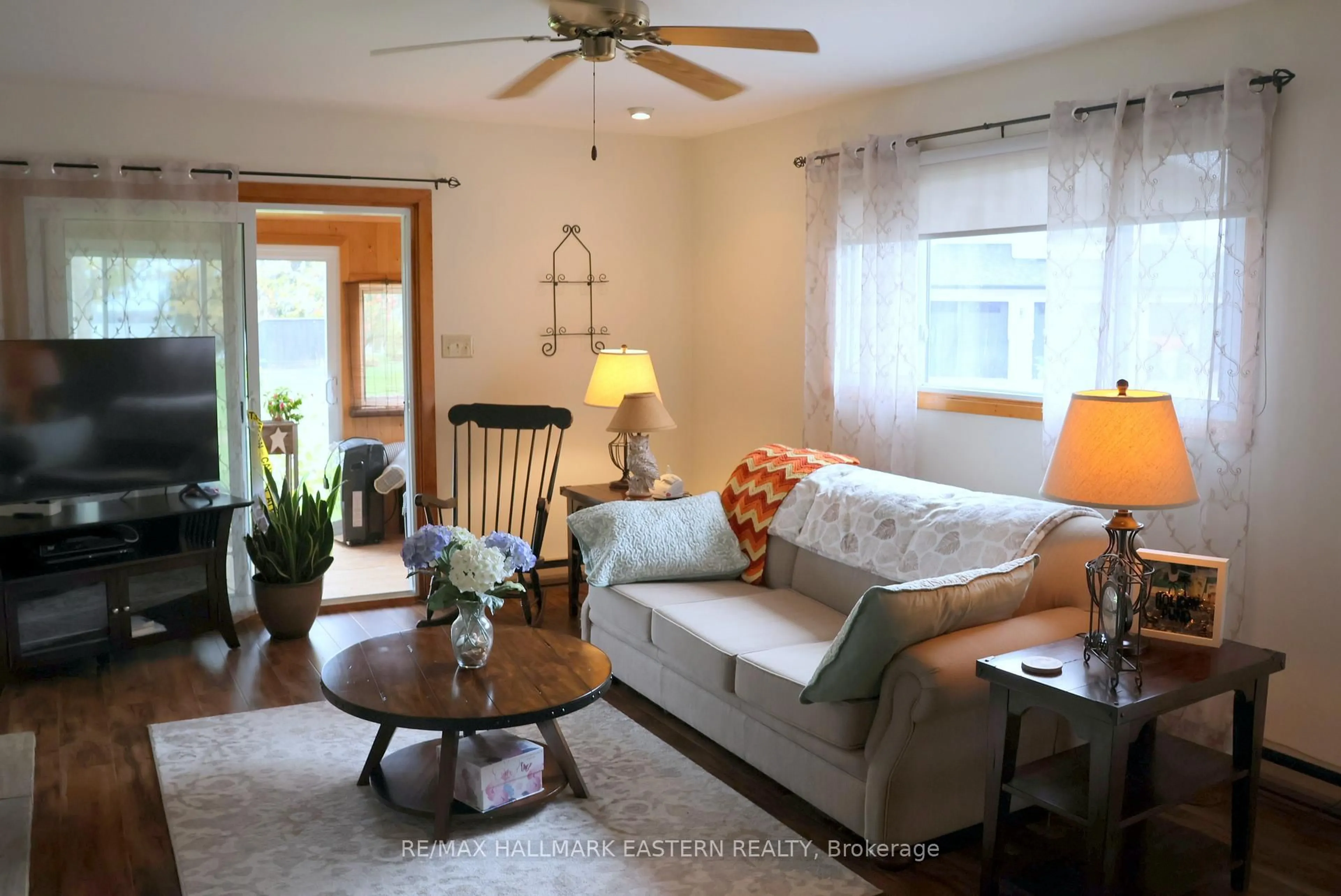 Living room with furniture, wood/laminate floor for 824 Sidney Dr, Selwyn Ontario K0L 1T0