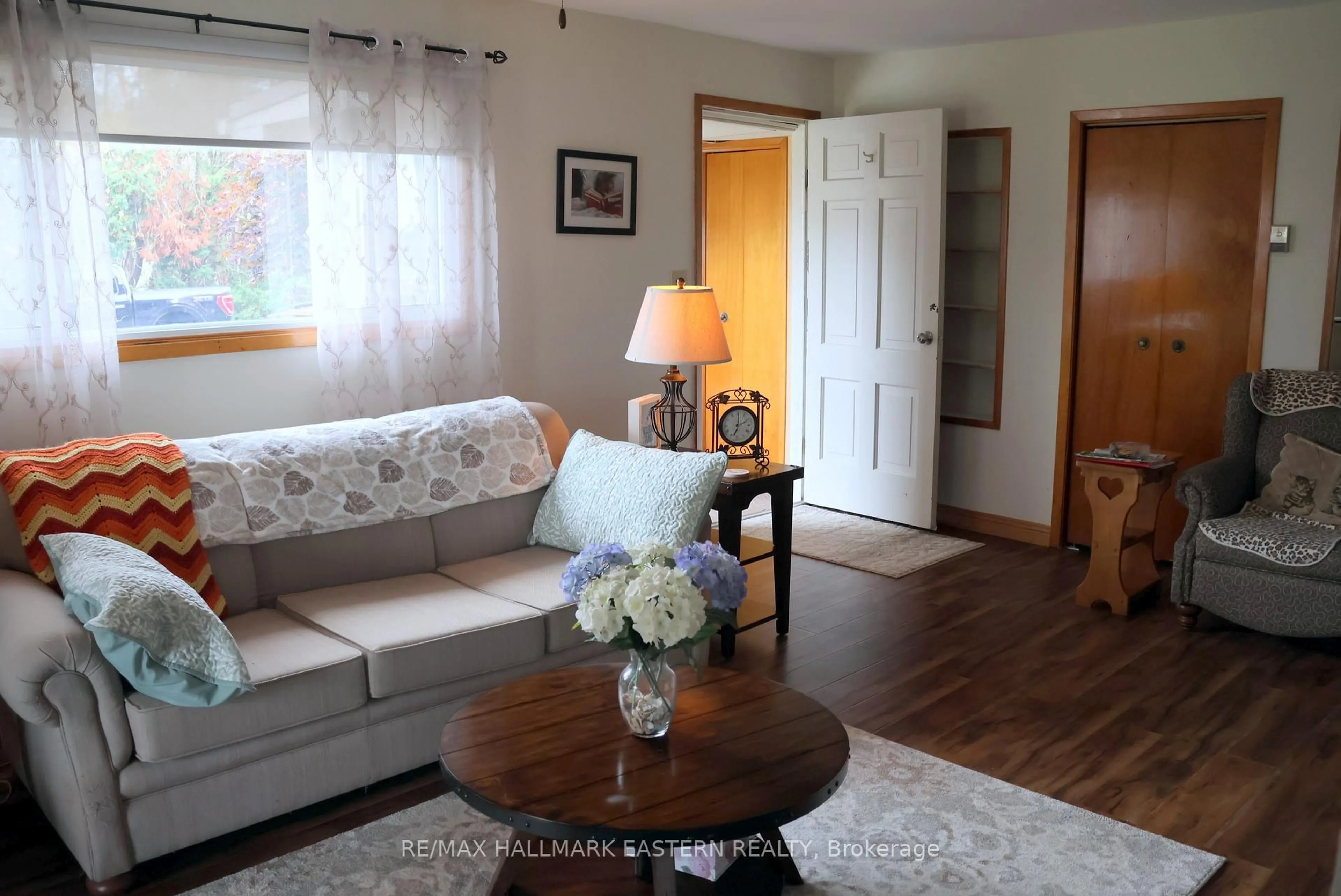Living room with furniture, wood/laminate floor for 824 Sidney Dr, Selwyn Ontario K0L 1T0