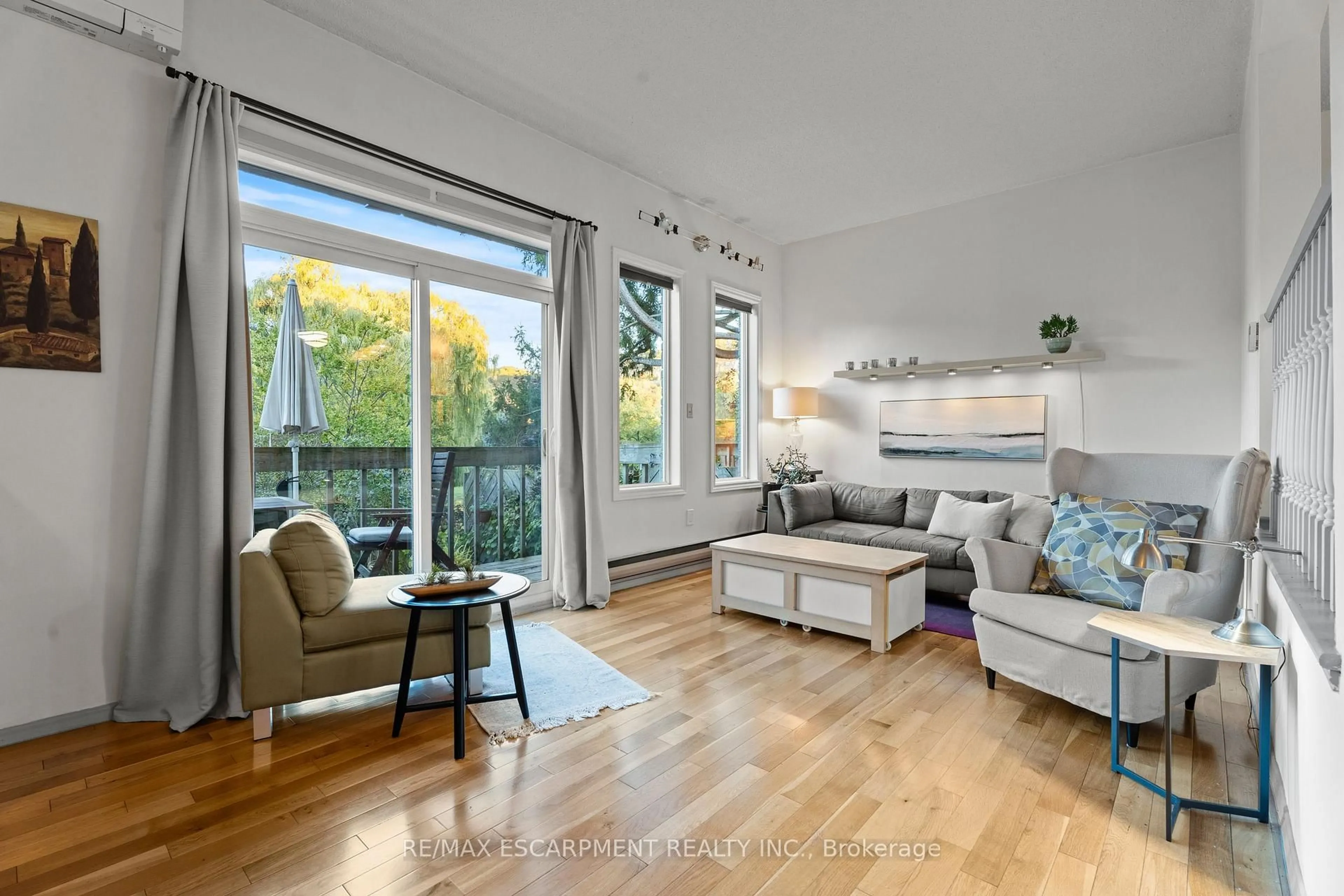 Living room with furniture, wood/laminate floor for 1967 Main St #7, Hamilton Ontario L8S 4P4