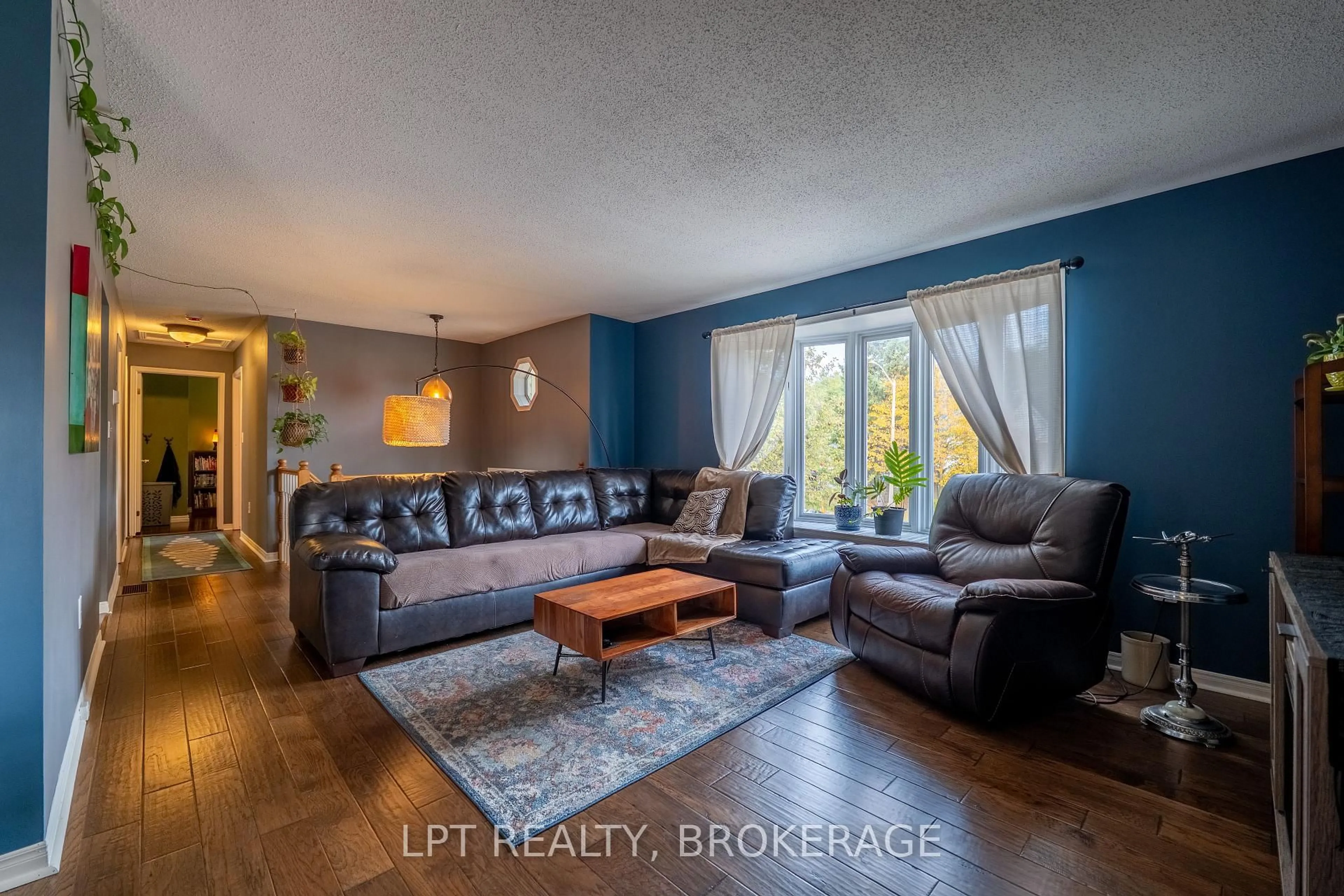 Living room with furniture, wood/laminate floor for 697 Macdonald Dr, Gananoque Ontario K7G 3C4