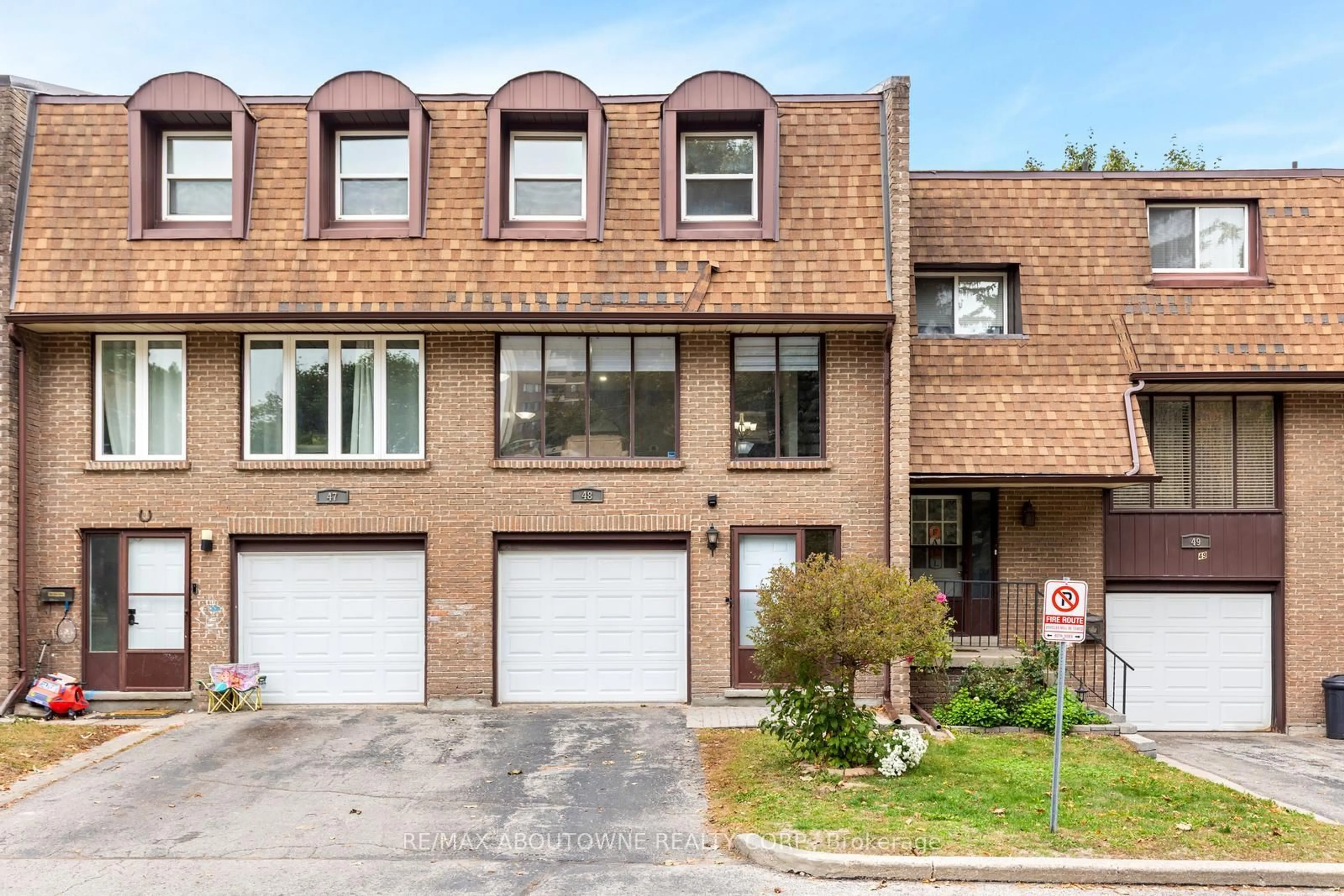 Home with brick exterior material, street for 49 Cedarwoods Cres #48, Kitchener Ontario N2C 2L1