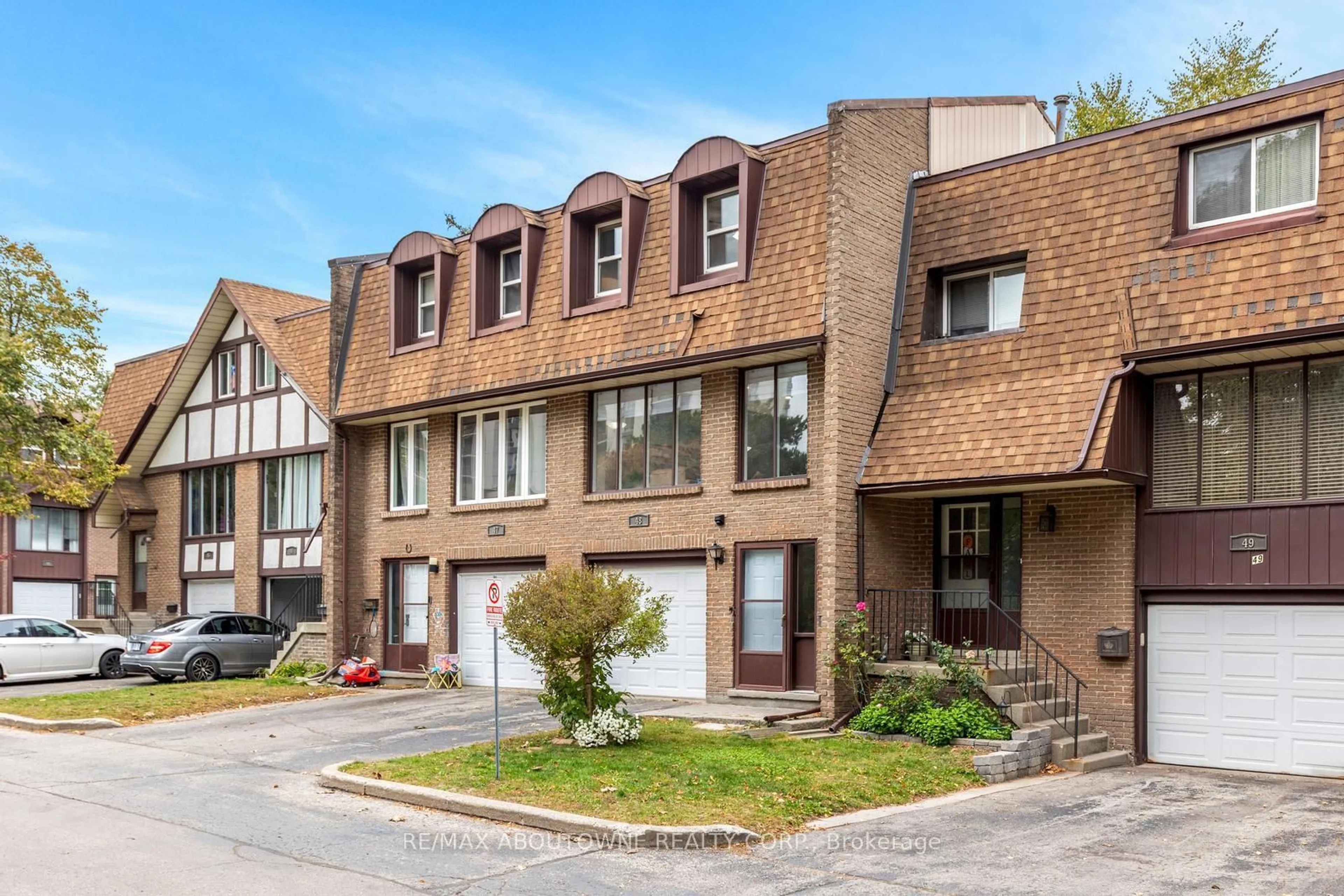 Home with brick exterior material, street for 49 Cedarwoods Cres #48, Kitchener Ontario N2C 2L1