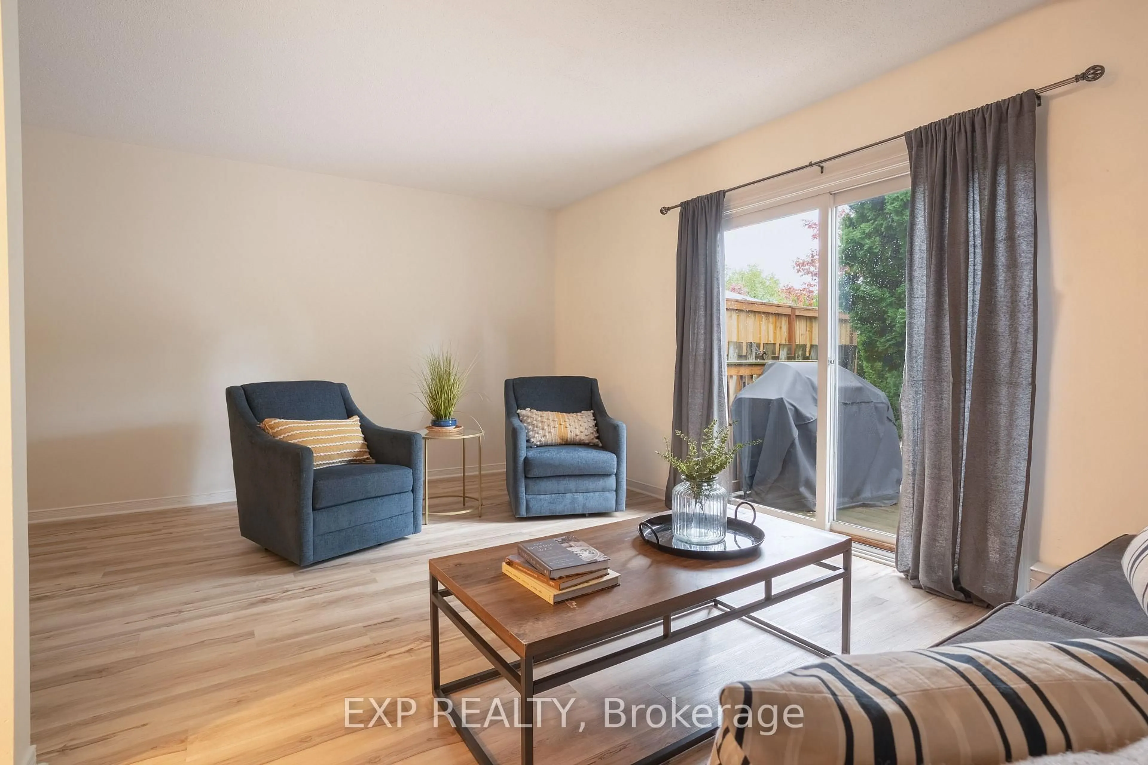 Living room with furniture, wood/laminate floor for 38 Elma St #8, St. Catharines Ontario L2N 6Z3