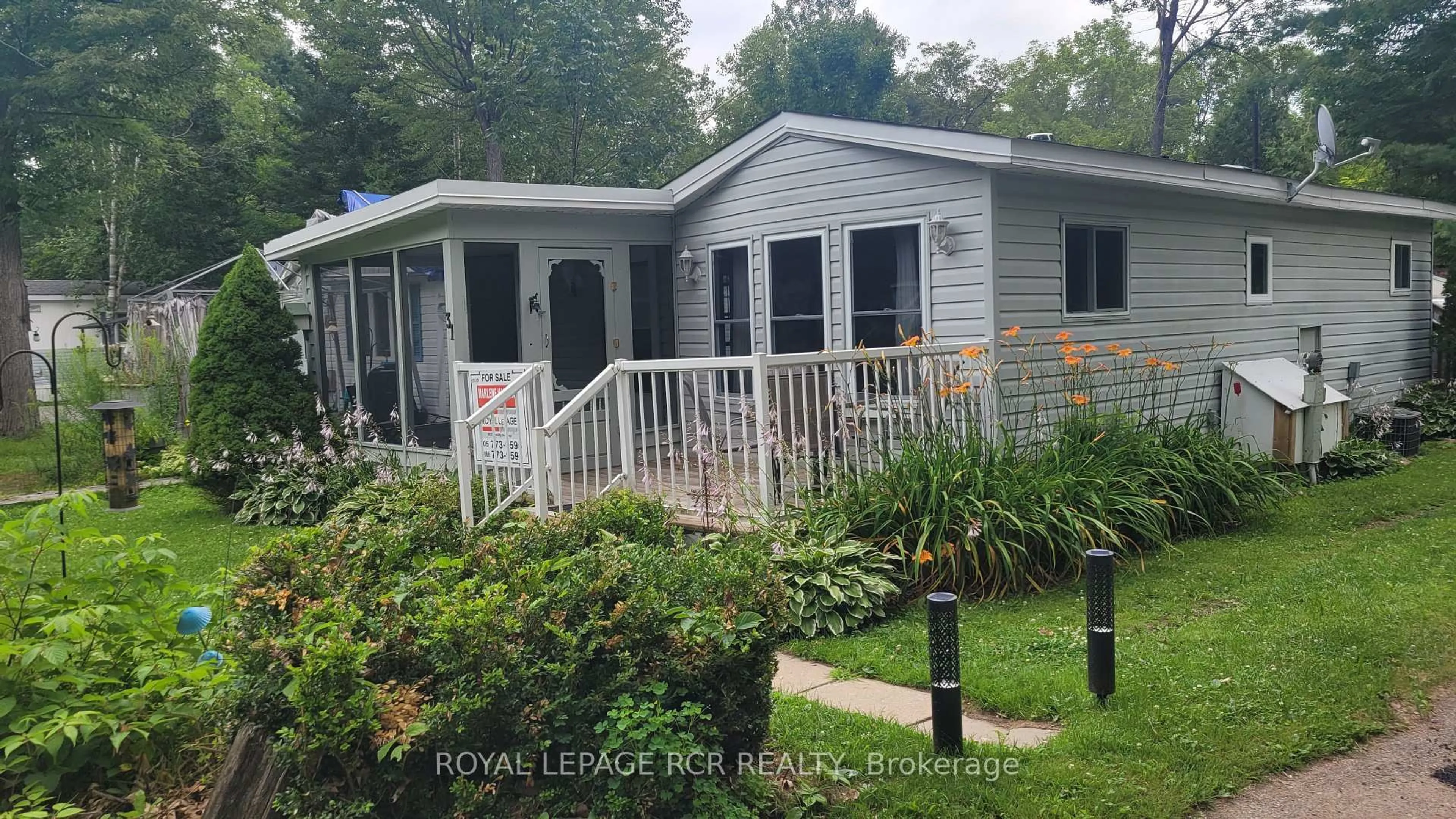 Home with vinyl exterior material, street for 1007 Racoon Rd #31, Gravenhurst Ontario P1P 1R1